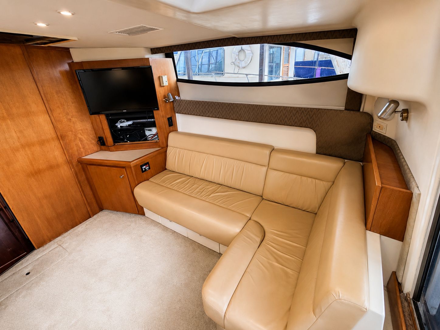 Interior of the 2001 Carver 350 Mariner with beige sofa and TV.