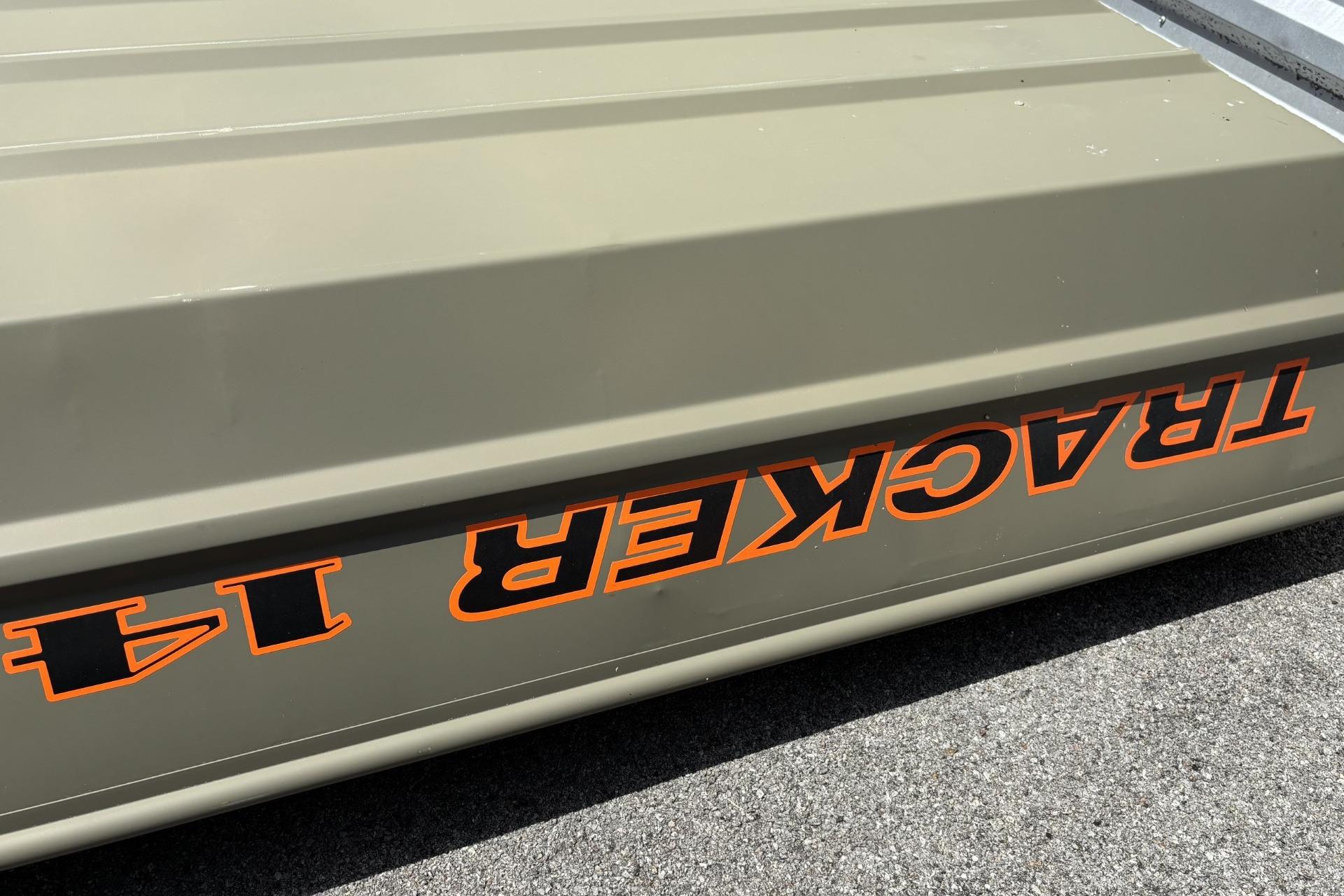 2026 Tracker Grizzly 14 Jon boat with bold orange lettering on a gray surface.