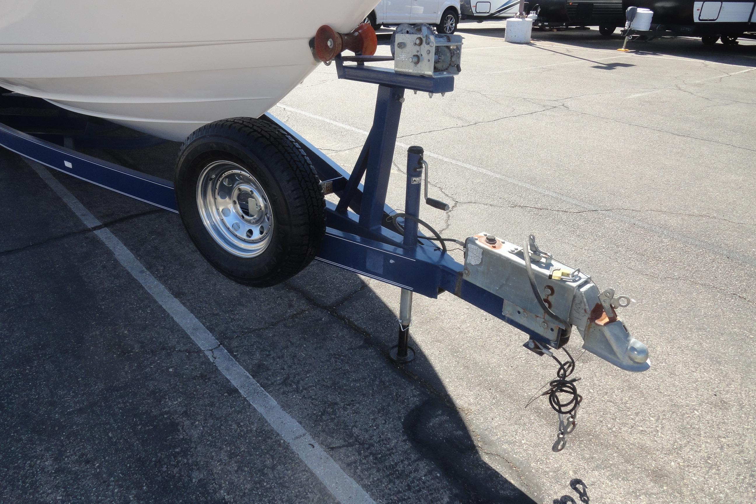 Trailer hitch of a 2001 Chaparral 265 SSi boat in a parking lot.
