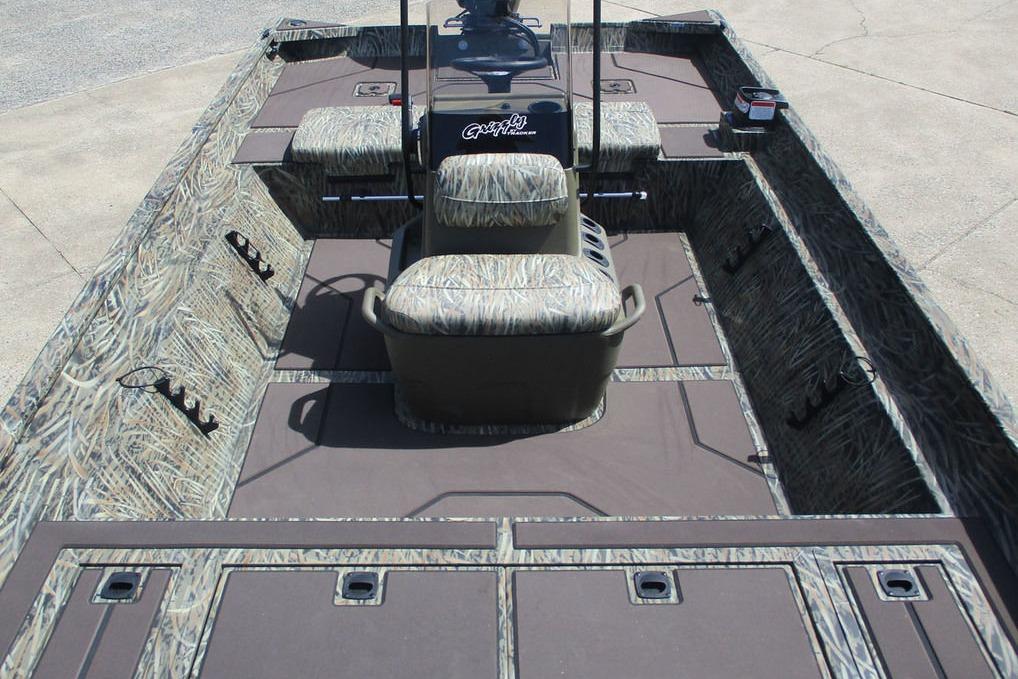 2026 Tracker Grizzly 2072 CC boat interior with camouflage seating and spacious deck layout.