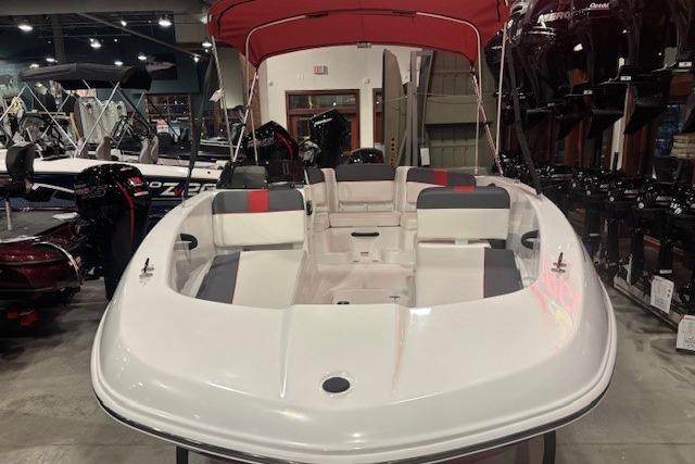 2026 Tahoe T18 boat with red canopy displayed in showroom.