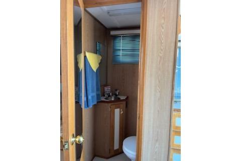 1994 PlayCraft 5215 bathroom interior with wooden cabinetry and blue towel.