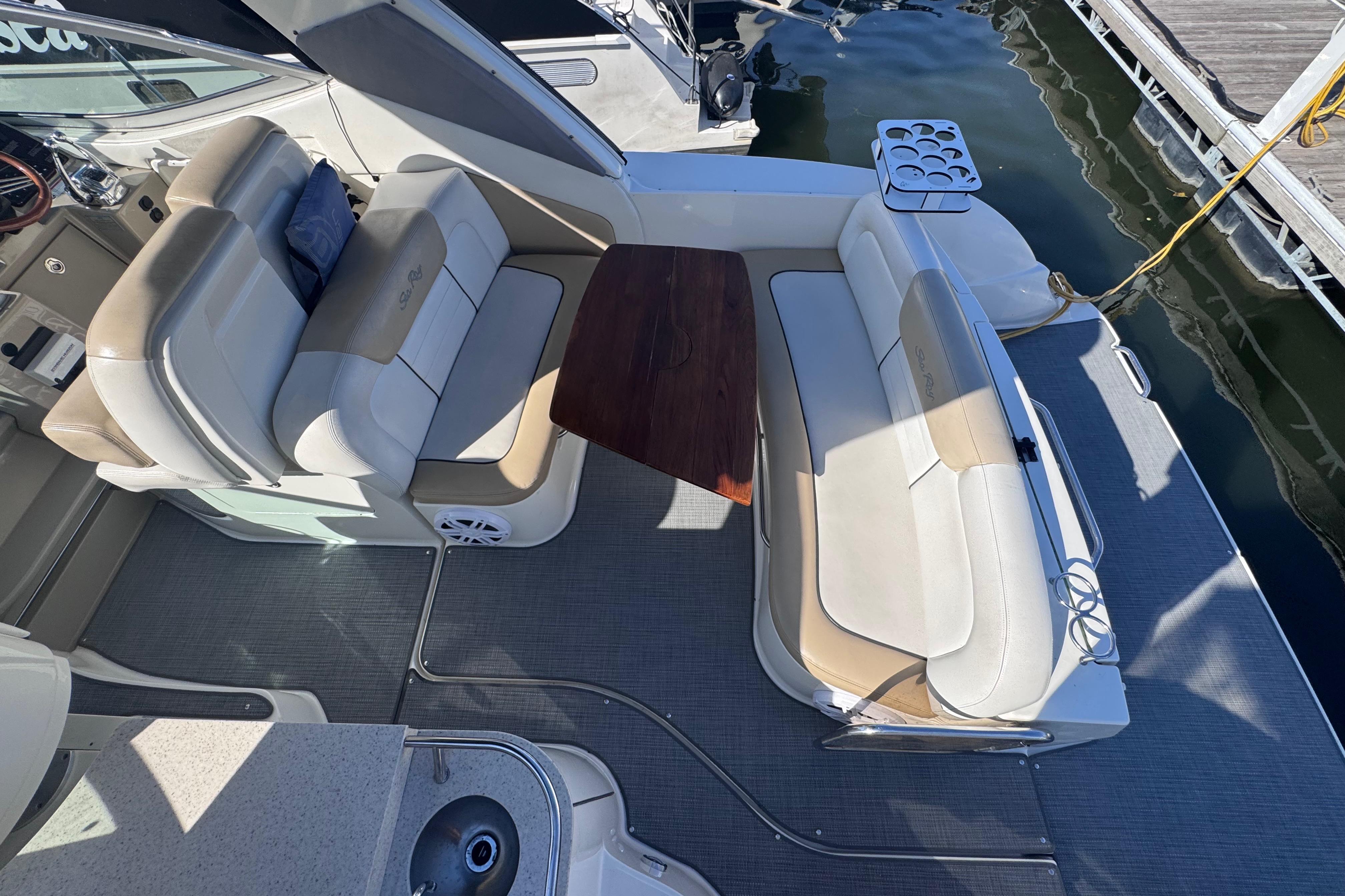 2008 Sea Ray 350 Sundancer boat interior with seating and table, docked at marina.