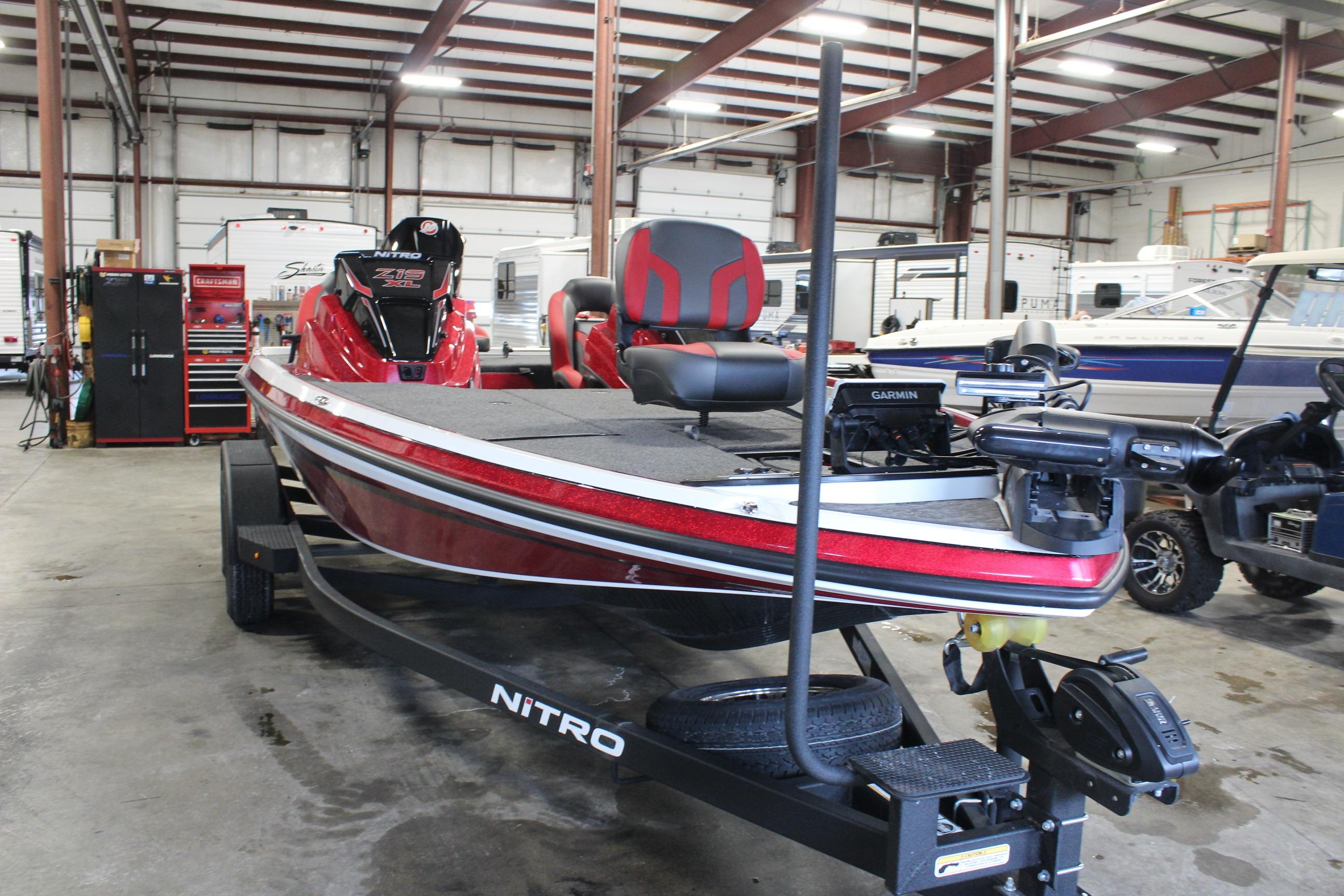 2026 Nitro Z19 XL Pro boat in a garage, featuring red and black design.