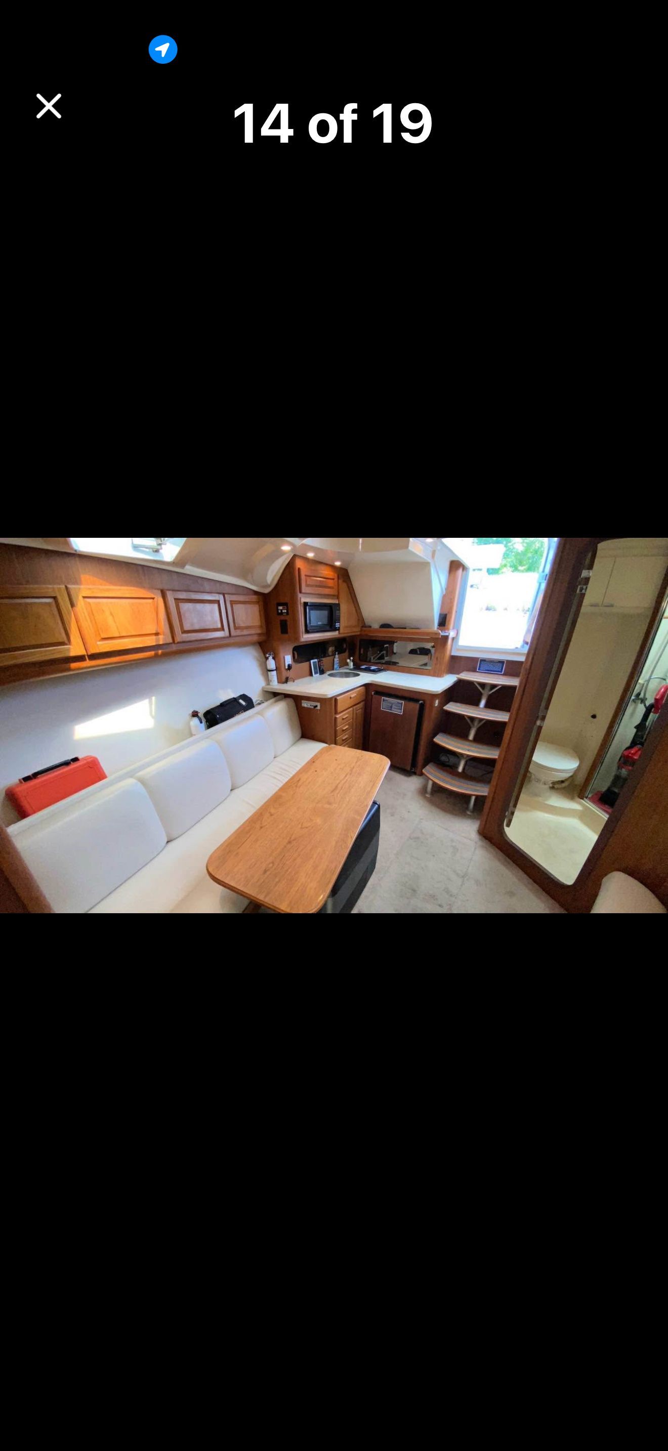 Interior of a 1999 Luhrs Sx36 with cozy seating area and kitchen.