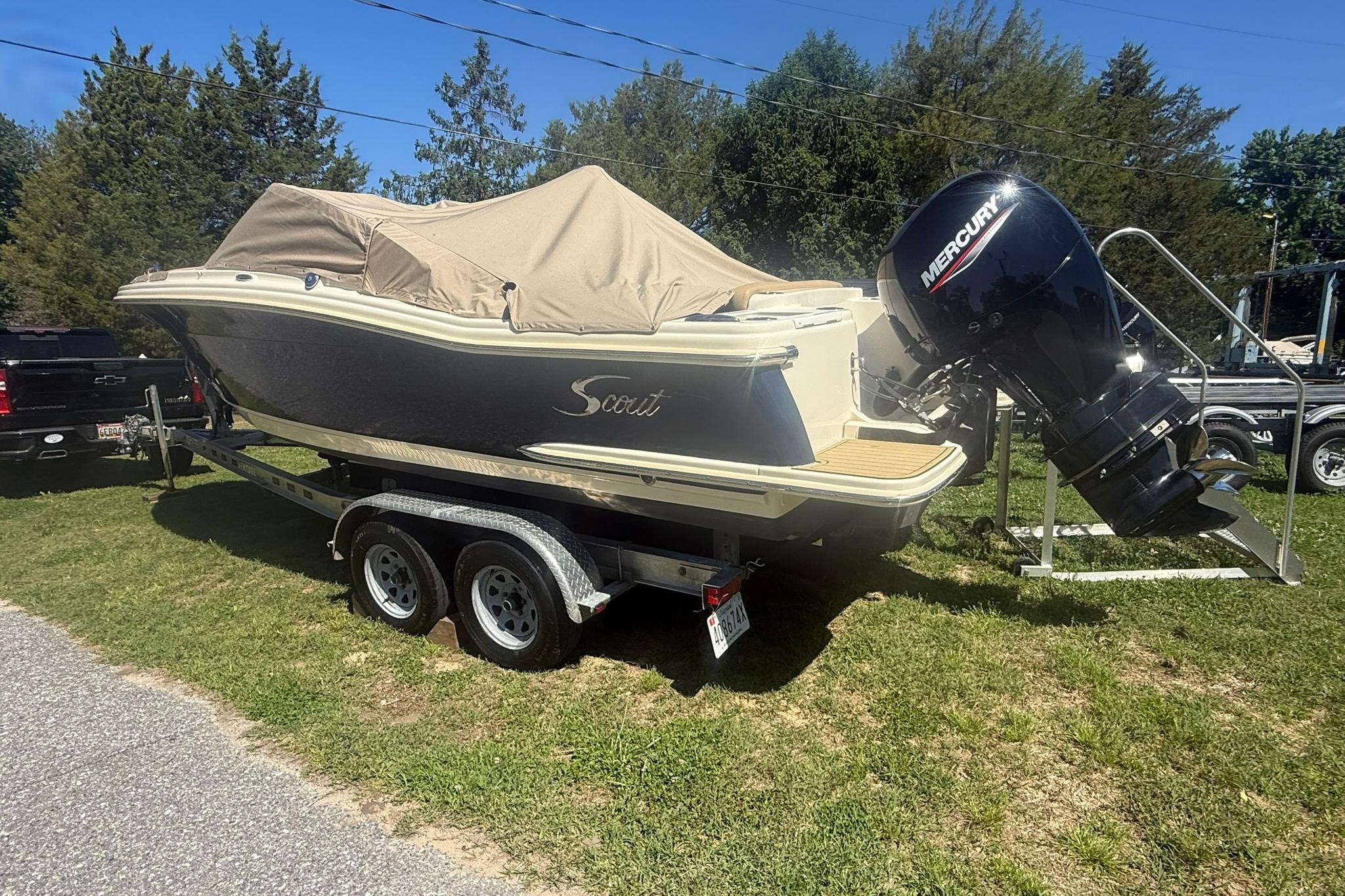 2021 Scout 215 Dorado boat on trailer with Mercury outboard engine.