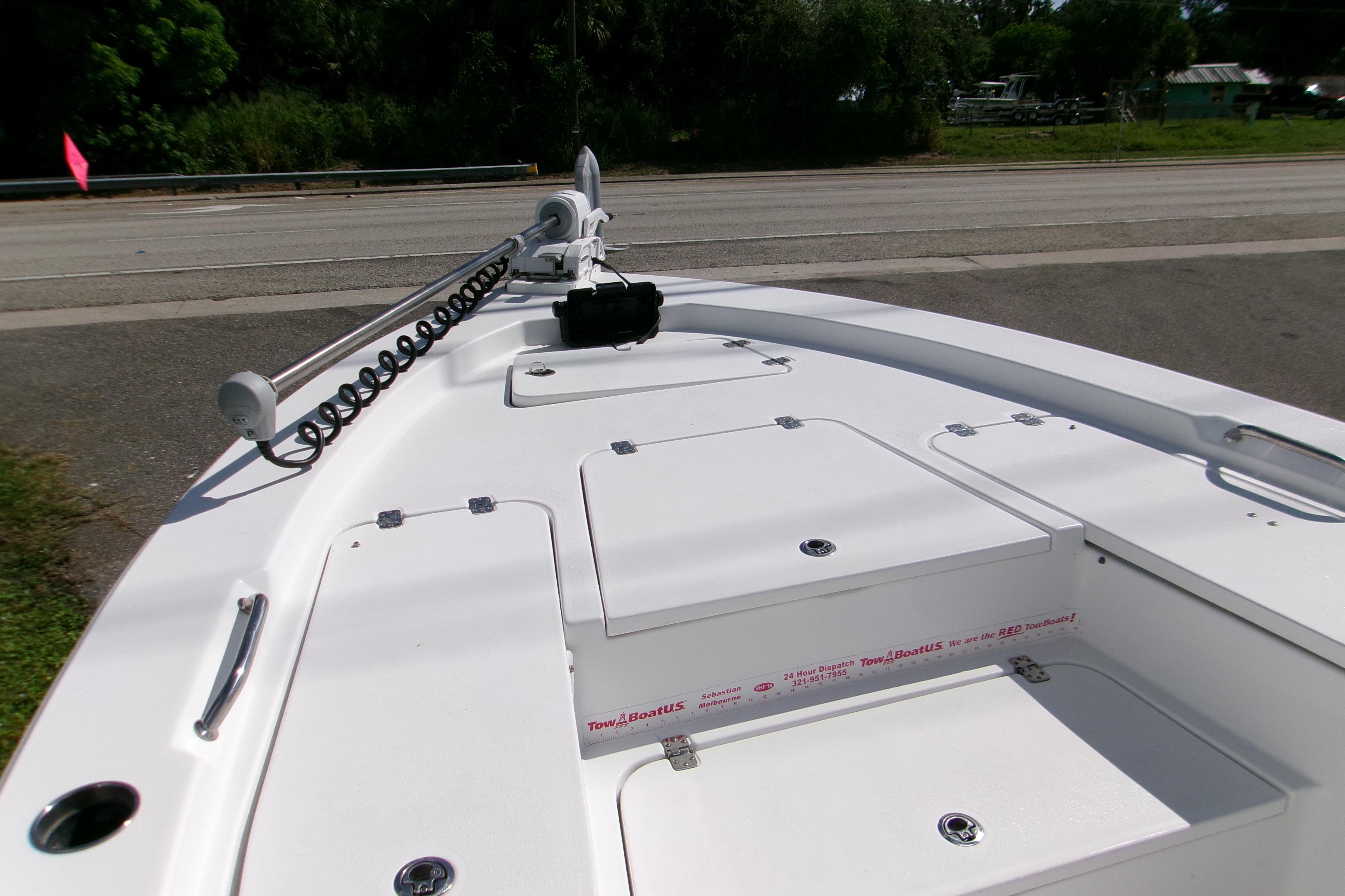 2024 Sportsman Masters 227 Bay Boat deck with storage compartments and trolling motor.