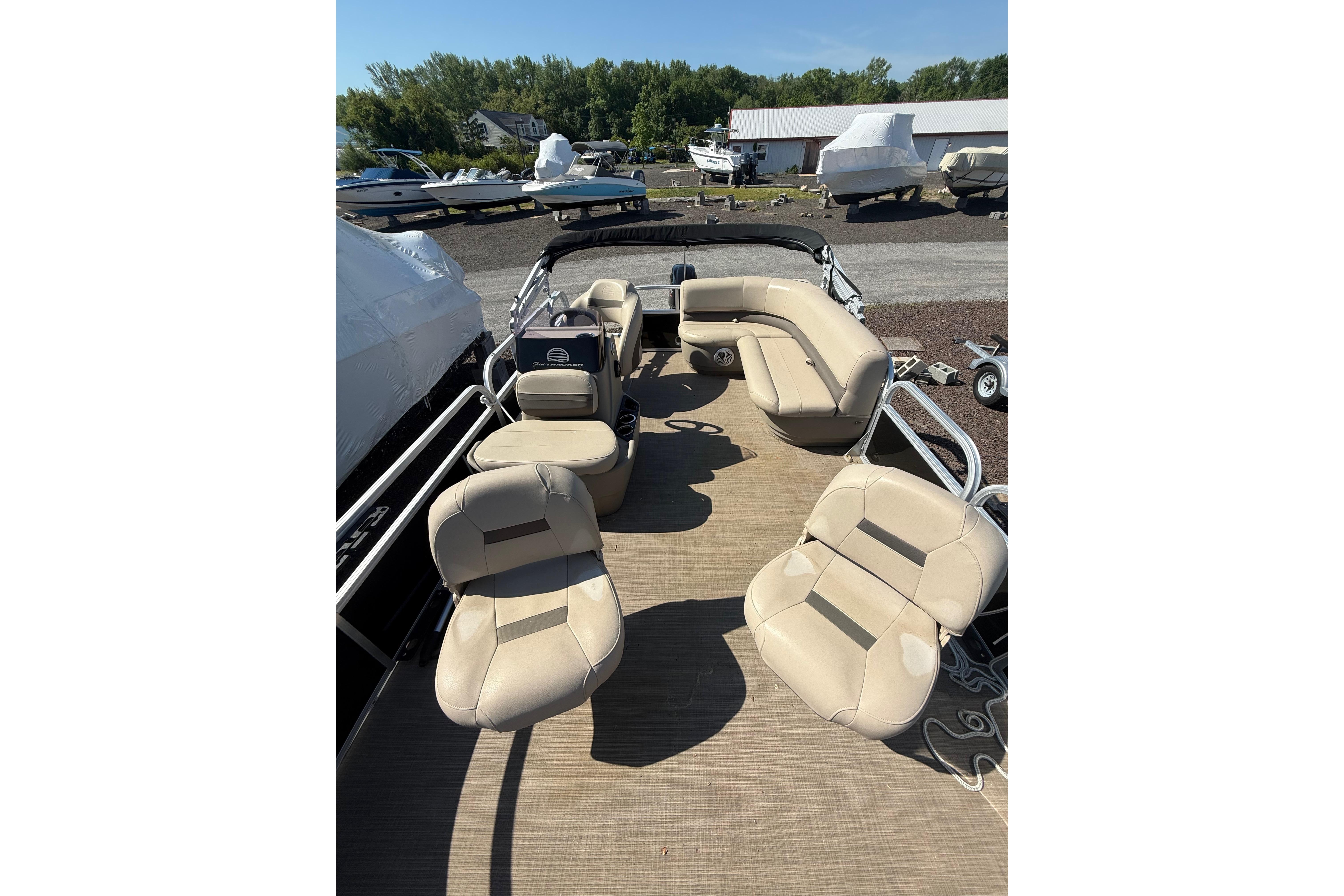 2021 Sun Tracker Bass Buggy 16 XL Select pontoon boat with beige seating.