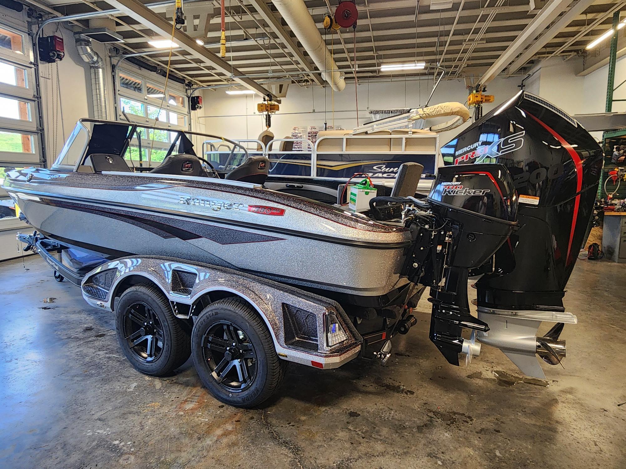 2025 Ranger 1880MS boat in a garage, featuring a powerful outboard motor.