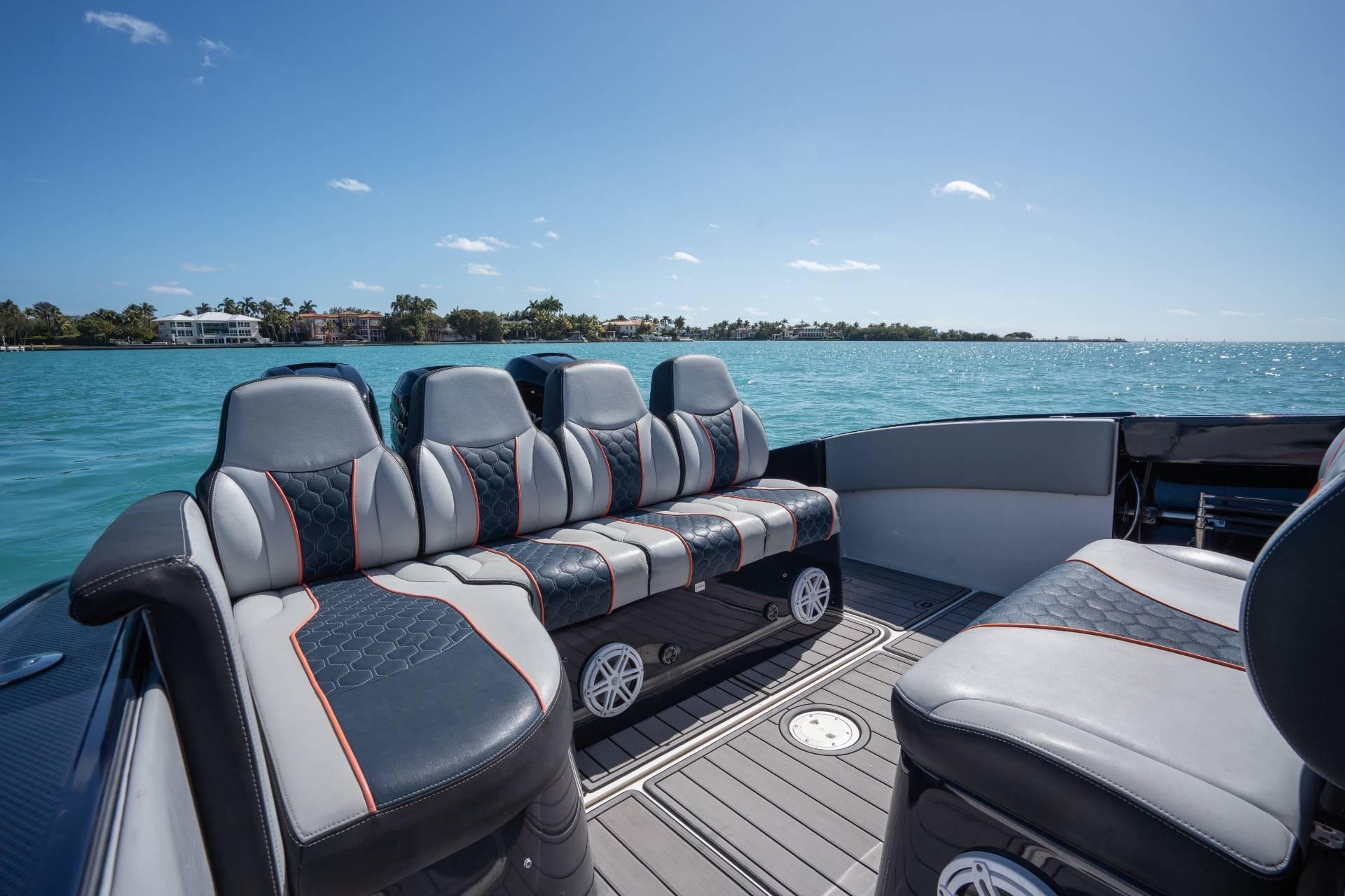 Luxurious seating on a 2014 Midnight Express 37 Open boat, cruising on clear blue waters.