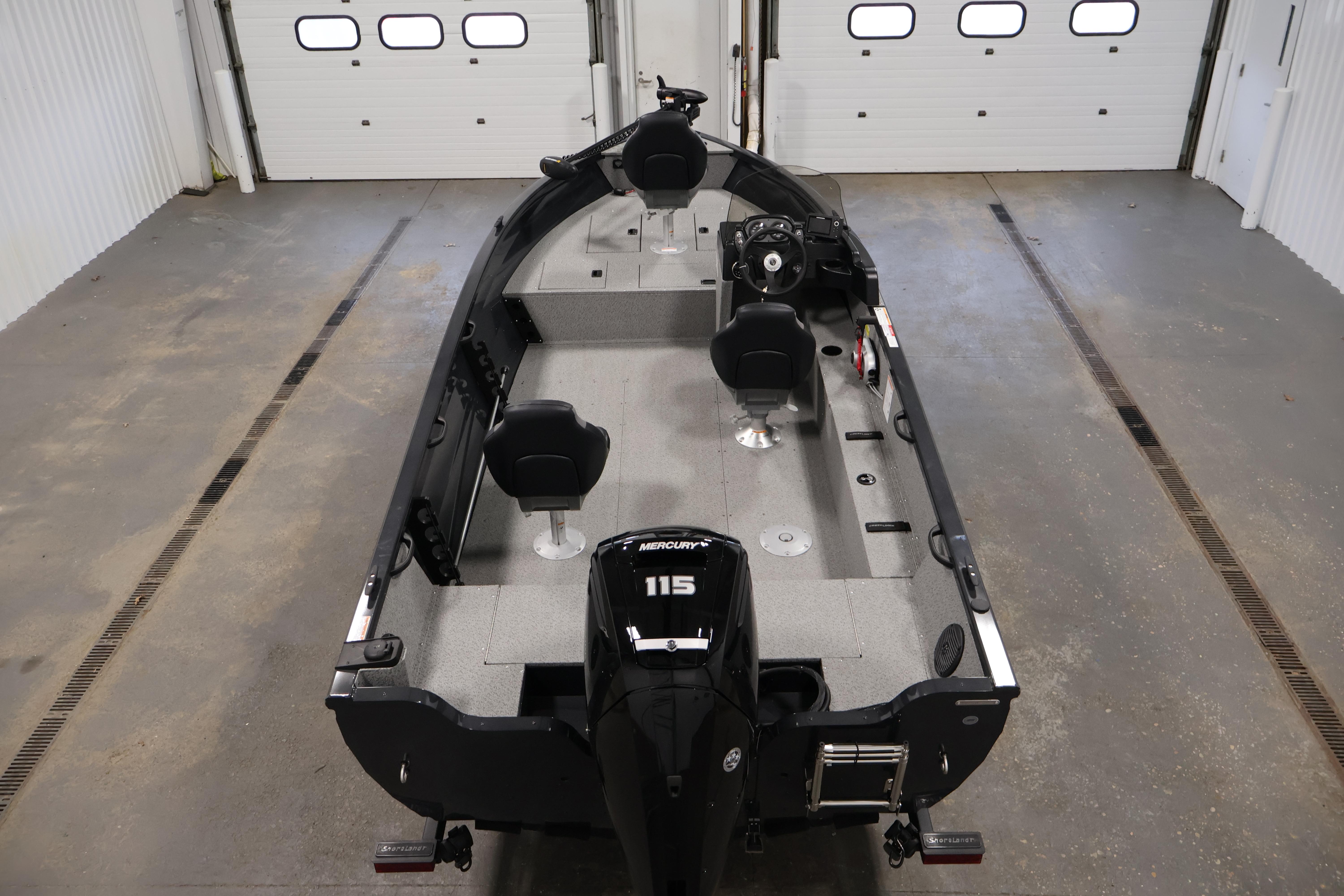 2026 Crestliner 1850 Kodiak SC fishing boat in a garage, featuring a Mercury 115 engine.