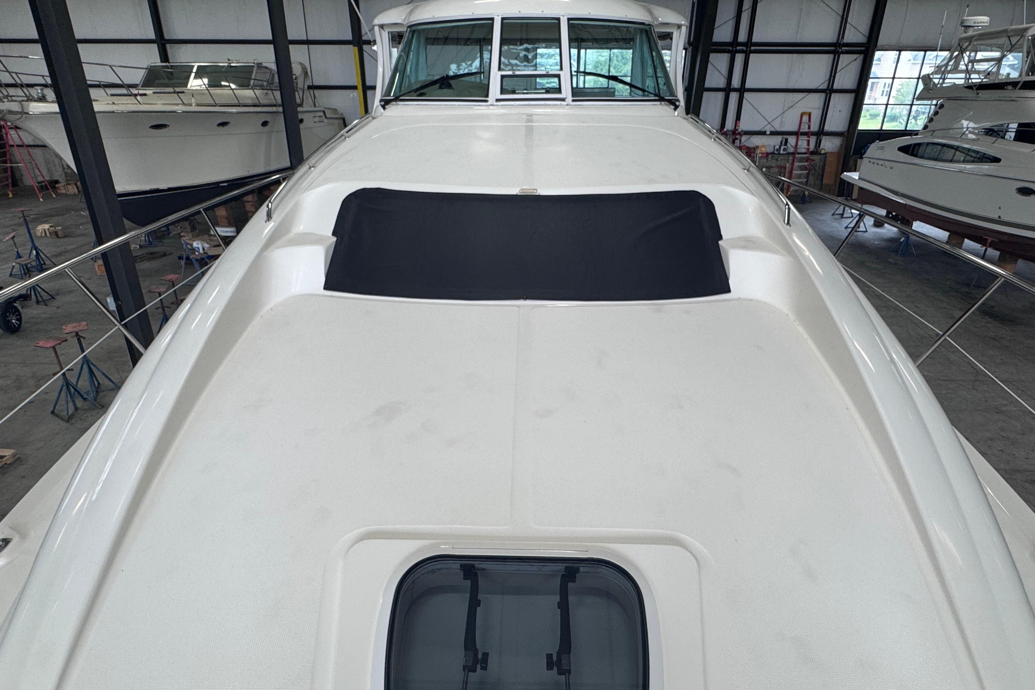 2004 Sea Ray 390 Motor Yacht in storage, showcasing sleek deck design.