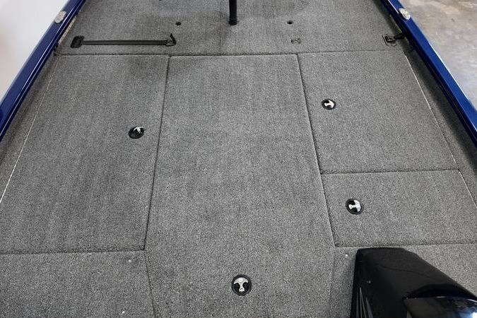 2024 Lowe Stinger 198 boat deck with gray carpet and storage compartments.