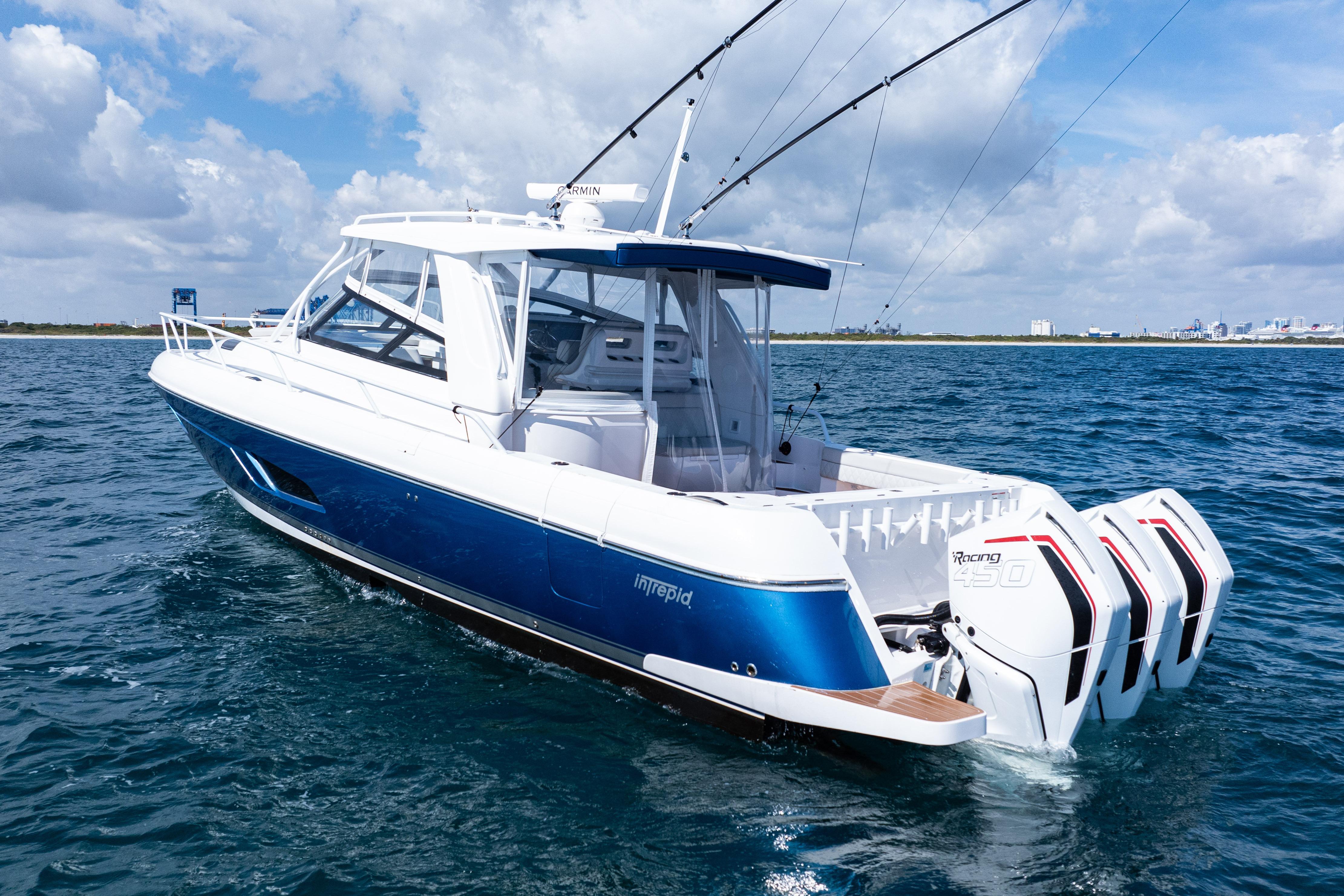 2018 Intrepid 438 Evolution boat on open water, featuring triple outboard engines.