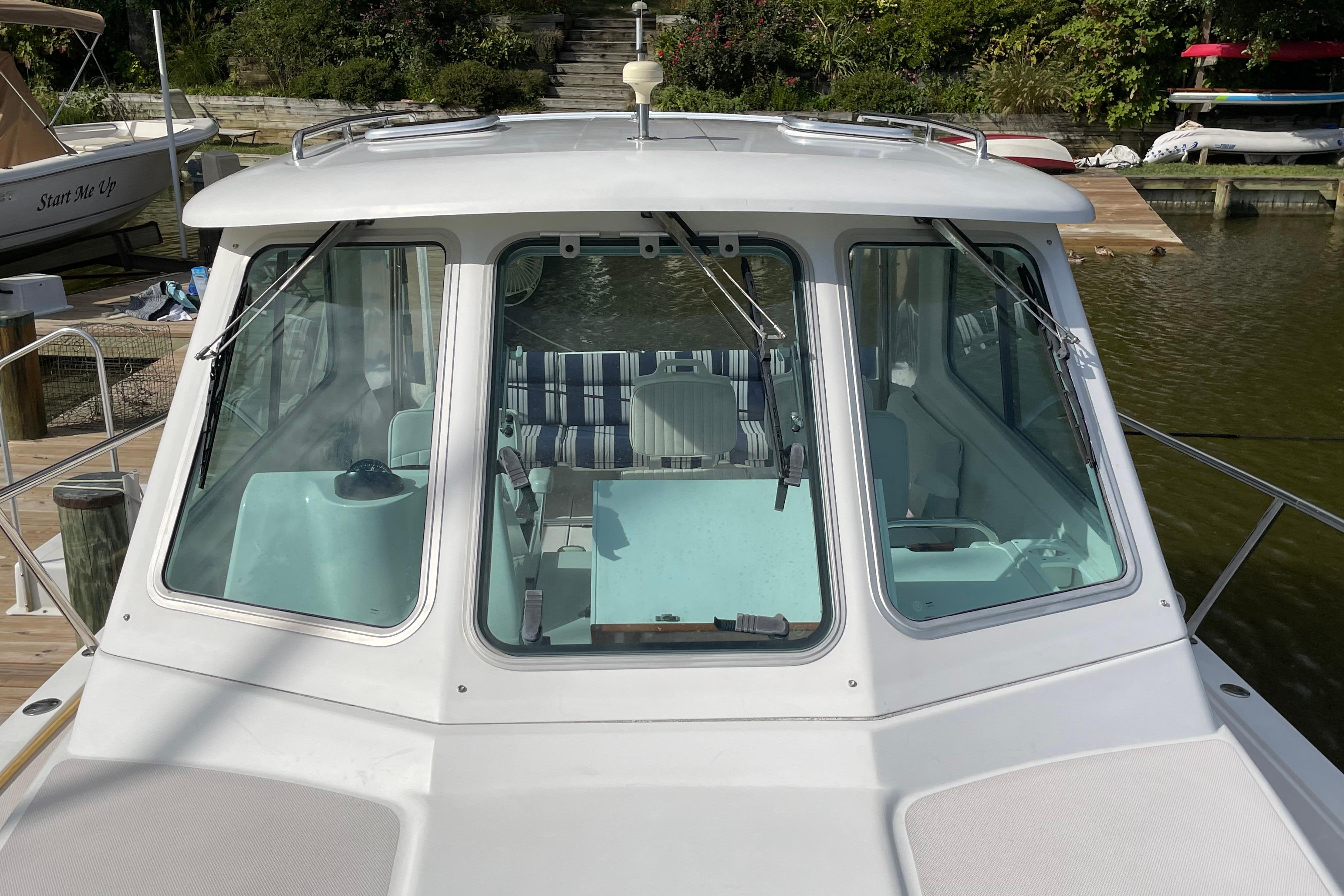 2007 Back Cove 29 boat docked, showcasing front cabin windows and interior seating.