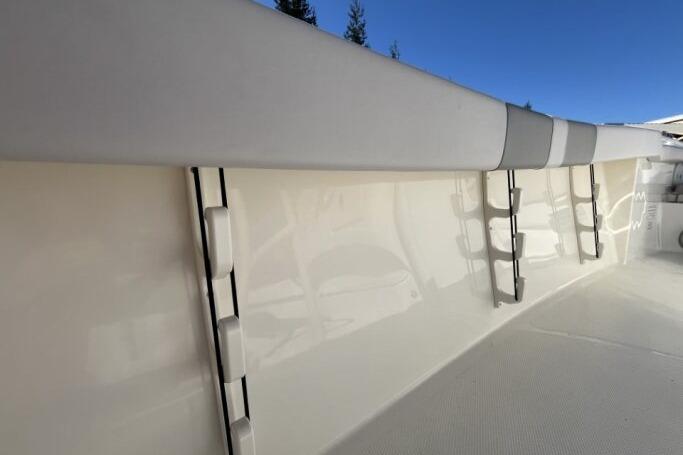2025 Mako 214 Center Console boat interior with padded side rails and ladder.