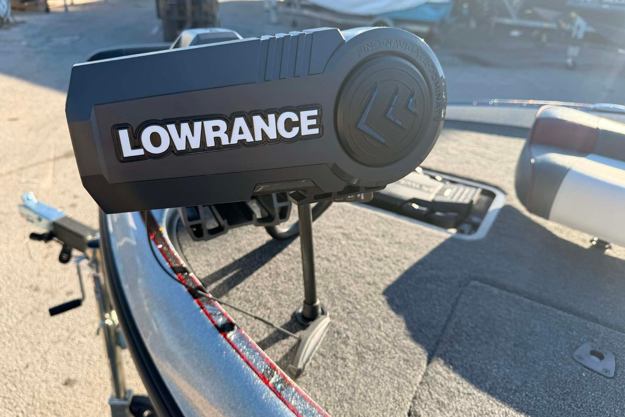 Lowrance device on 2026 Triton 179 TrX boat deck, sunny day.