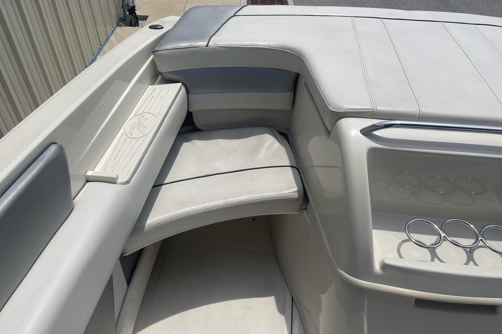 Interior of a 2010 Sea Ray 230 Bow Rider Select boat, featuring white seating and cup holders.
