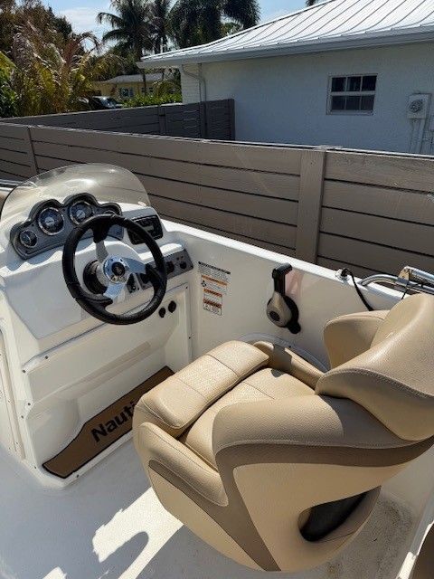 Interior view of a 2020 Nautic 203SC boat with steering console.