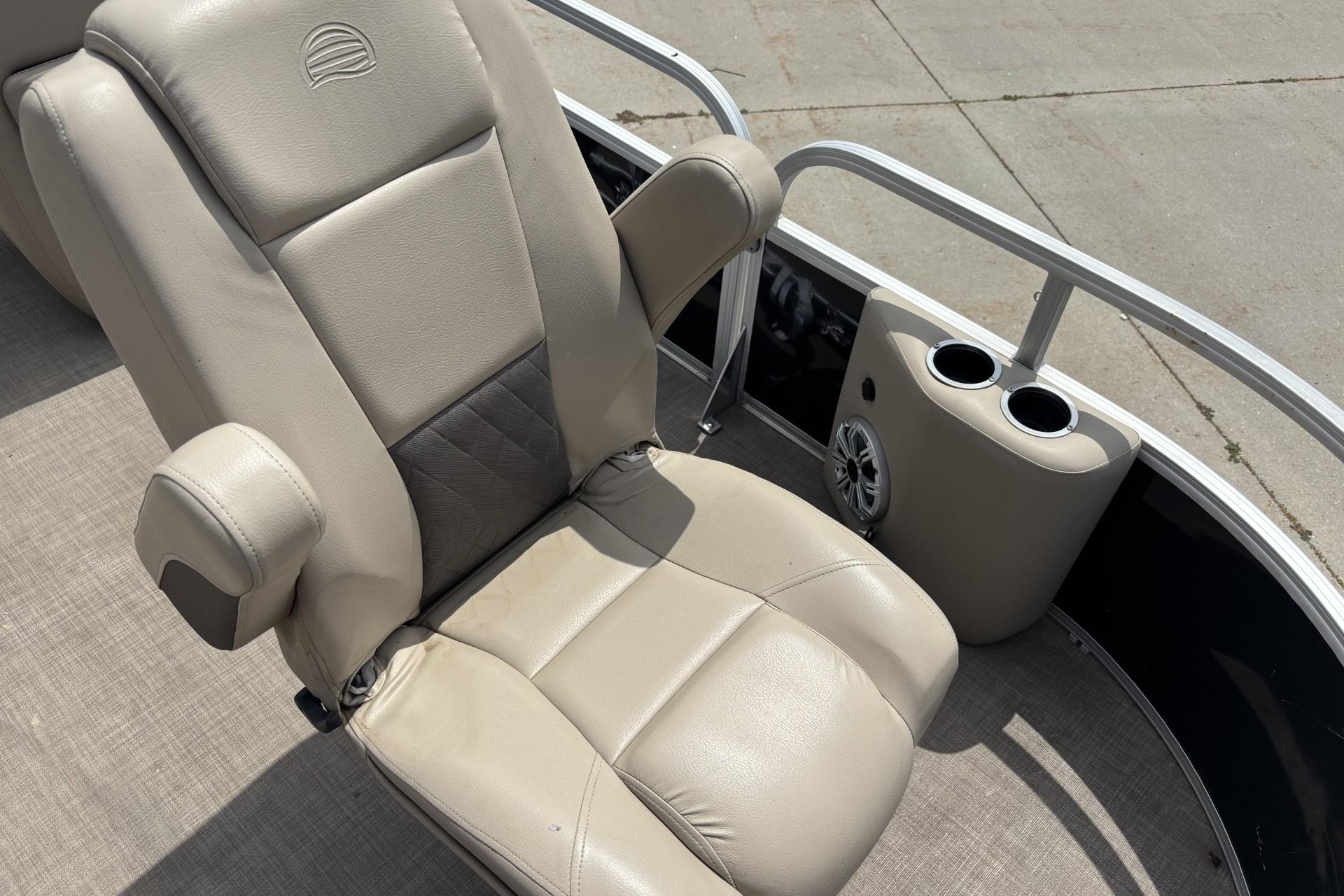2023 Sun Tracker SportFish 20 DLX boat seat with cup holders and speaker.
