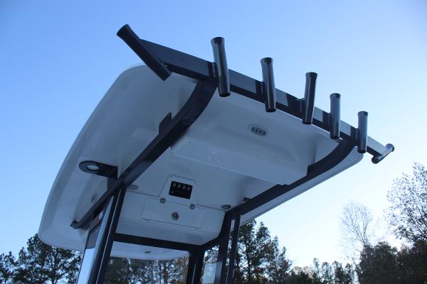 2025 Sea Fox 231 Bay Fox boat top with rod holders against blue sky.