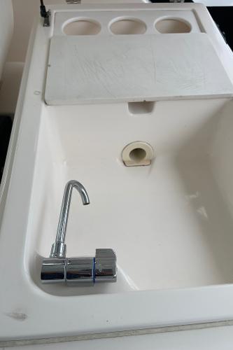 2003 Tiara Yachts 3500 Open sink with chrome faucet and cutting board.