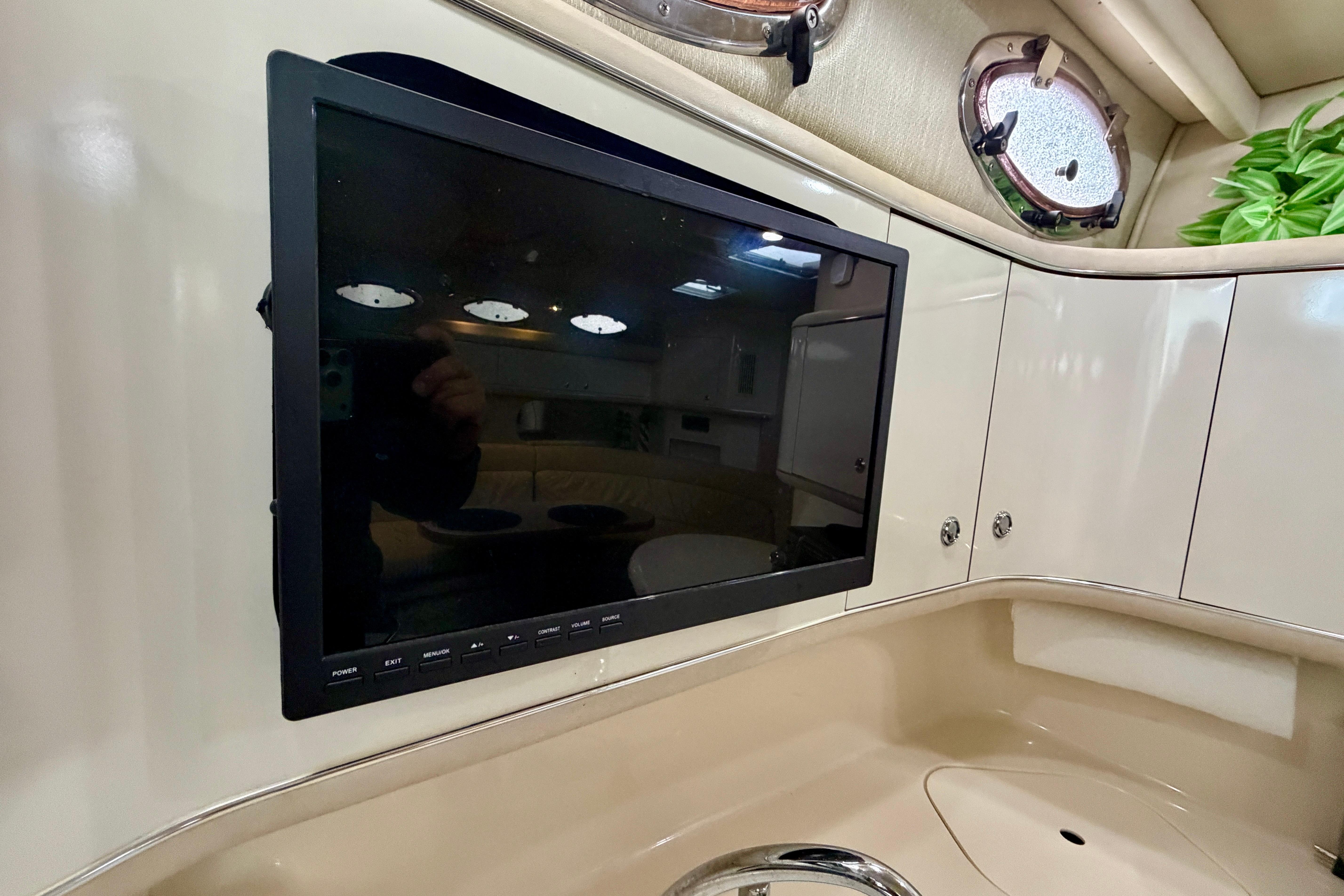 Flat-screen TV in the cabin of a 1995 Sea Ray 370 Sundancer yacht.