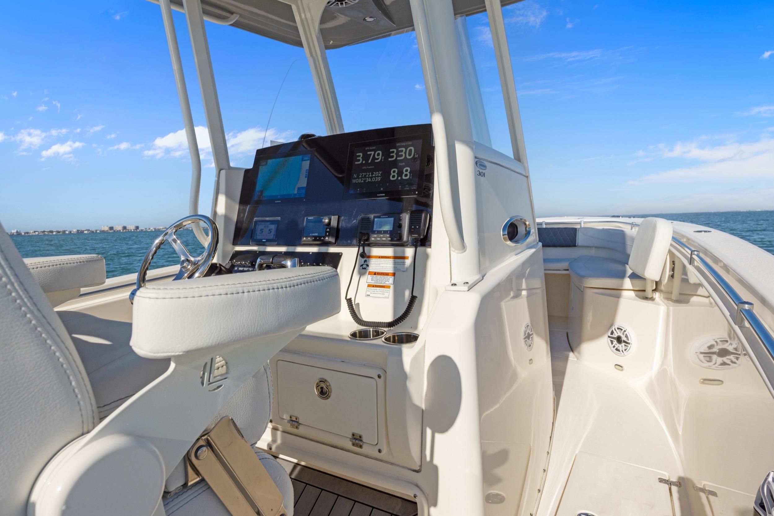 2023 Cobia 301 Center Console boat interior with modern dashboard and ocean view.
