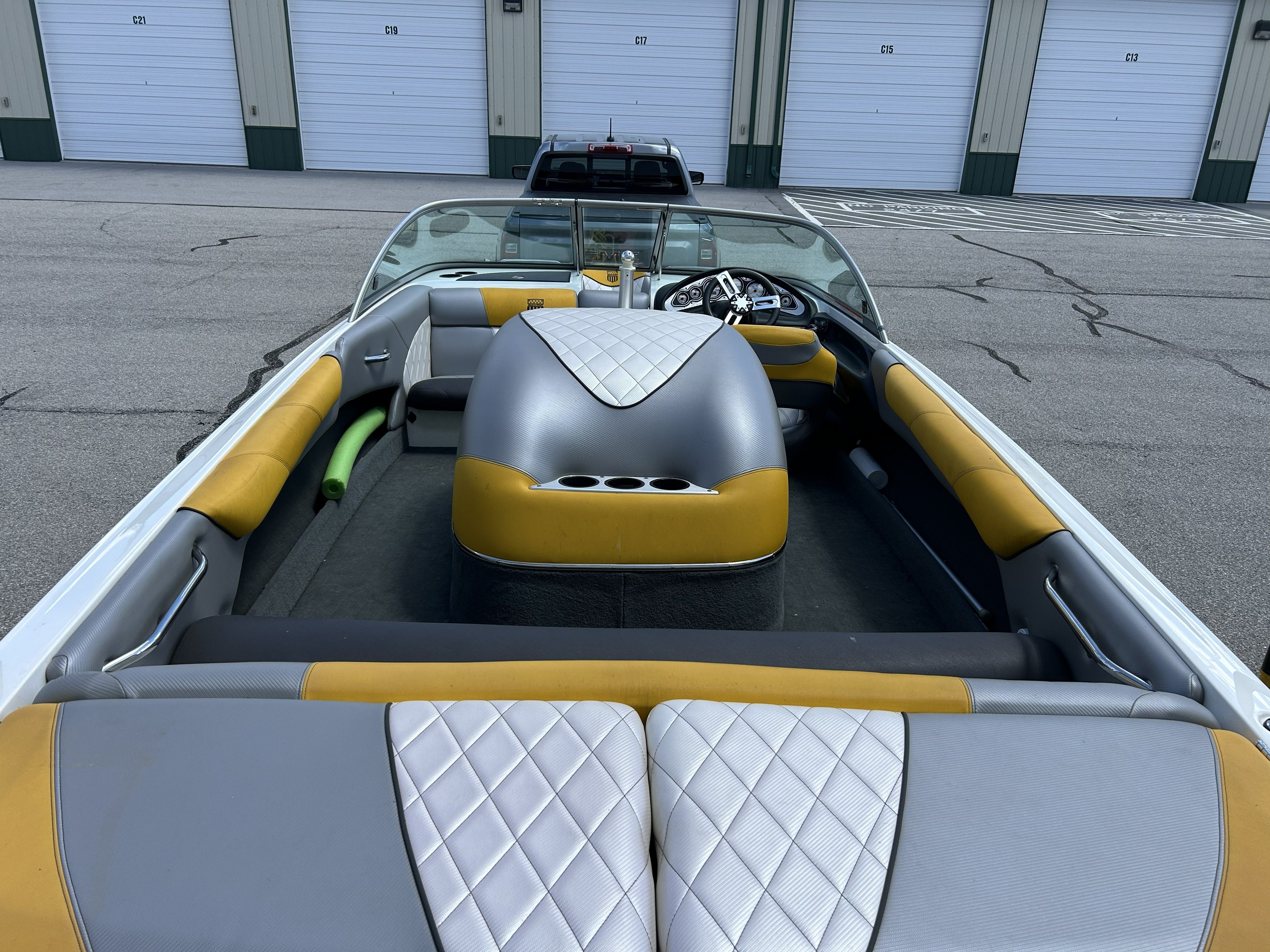 Interior view of a 2011 MasterCraft PS197 boat with yellow and gray seating.