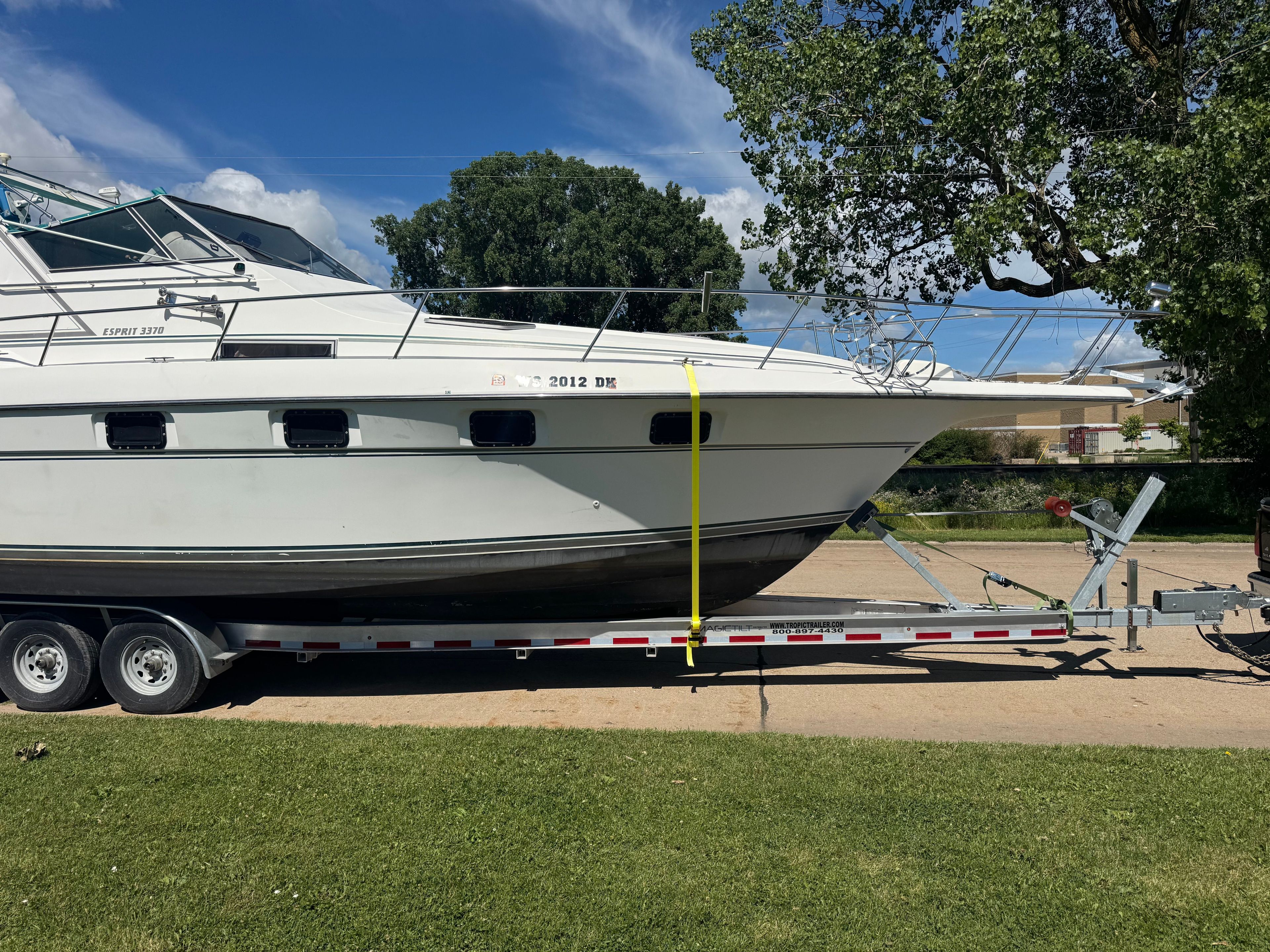 A 1992 Cruisers Yachts Esprit 3370 on a trailer, ready for transport.