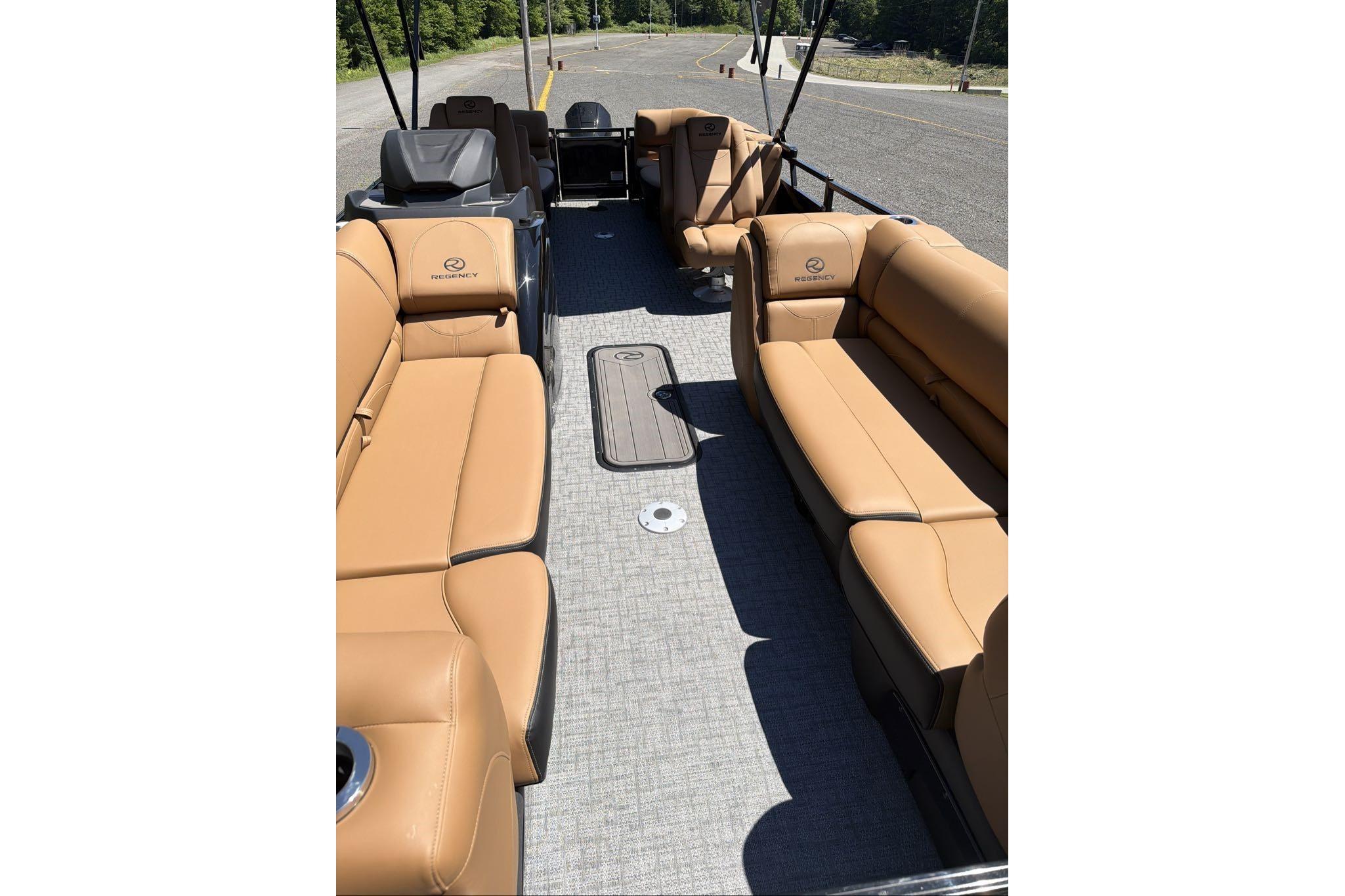 Luxurious 2026 Regency 230 DL pontoon boat with tan leather seating and spacious interior.