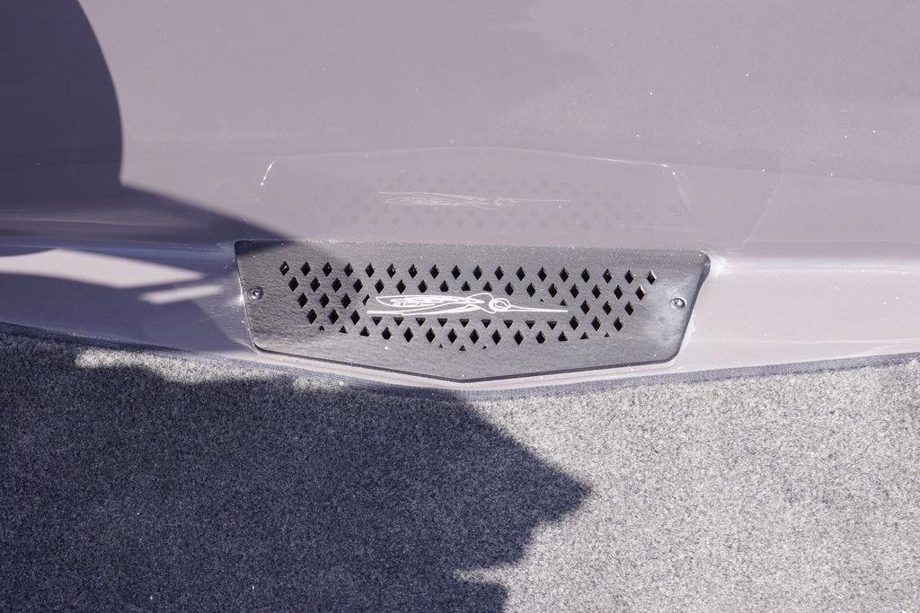 2026 Skeeter ZXE21 boat detail with vented panel and logo on carpeted surface.