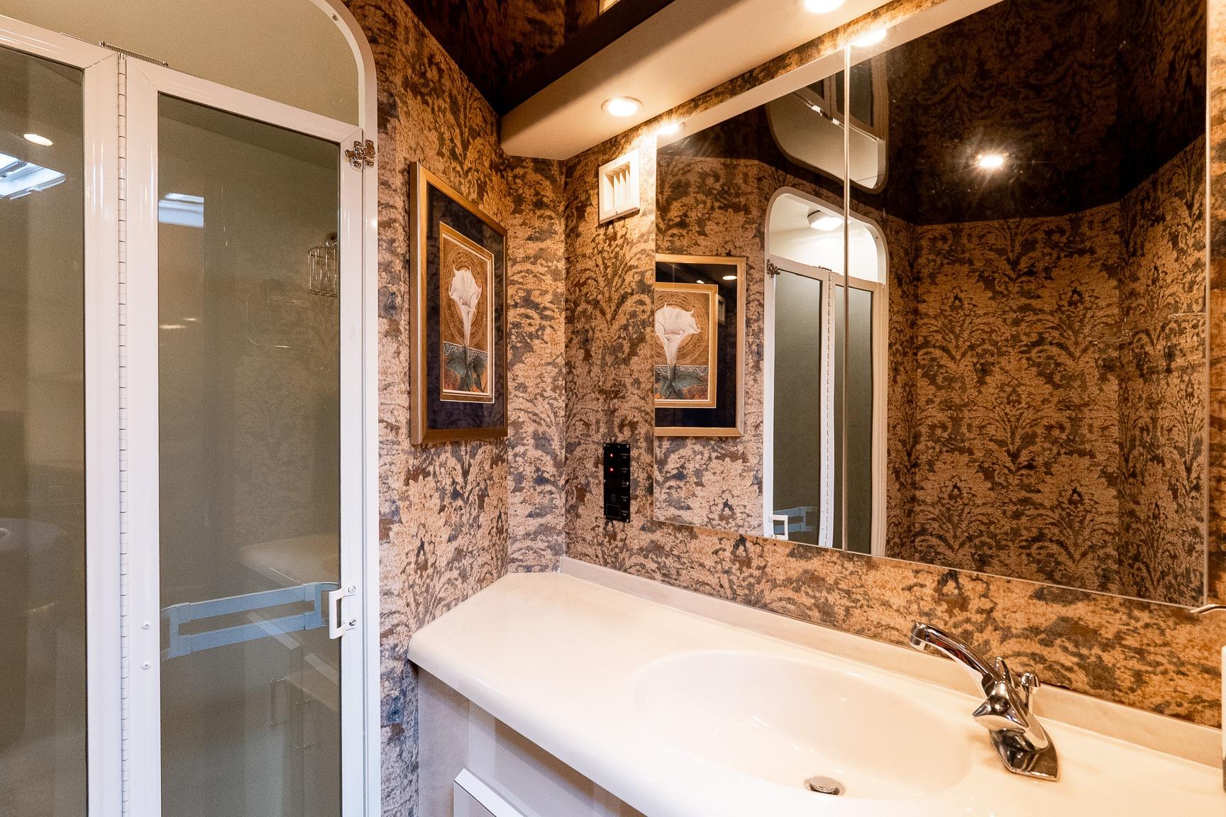 Luxurious bathroom in 2000 Viking 50' Convertible yacht with elegant decor and modern fixtures.