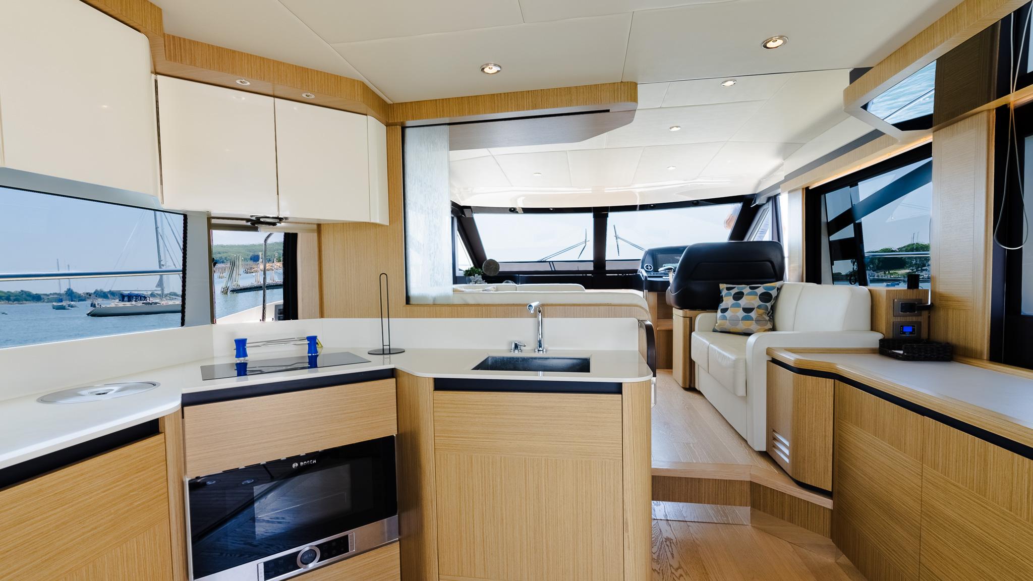 Luxurious interior of 2017 Absolute 50 Fly yacht with modern kitchen and seating area.