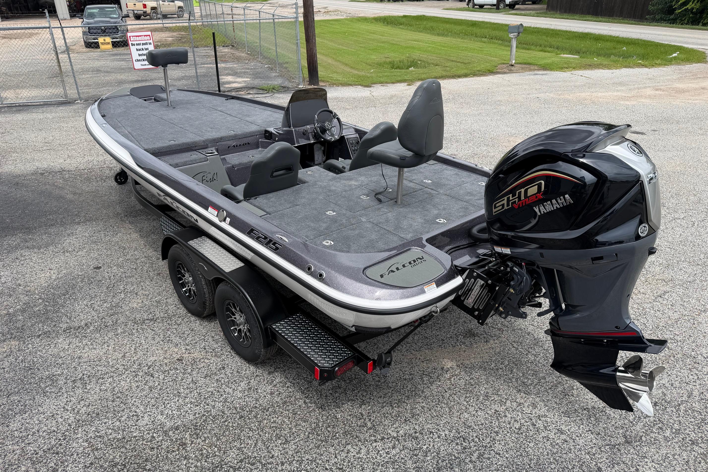 2027 Falcon Boats F215 with Yamaha engine, parked on a trailer in a lot.