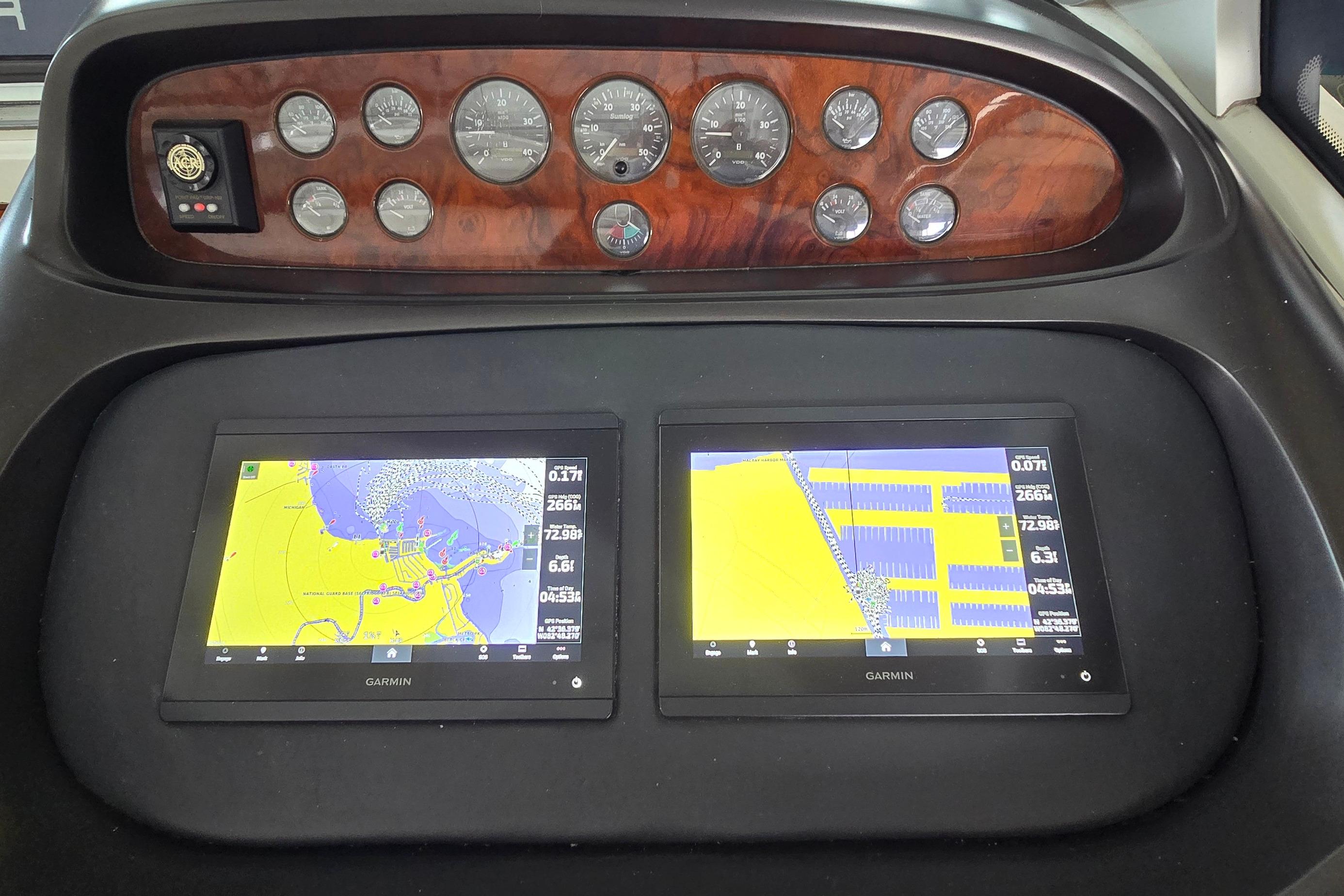Dashboard of 2004 Sunseeker Camargue 50 with Garmin navigation displays and analog gauges.