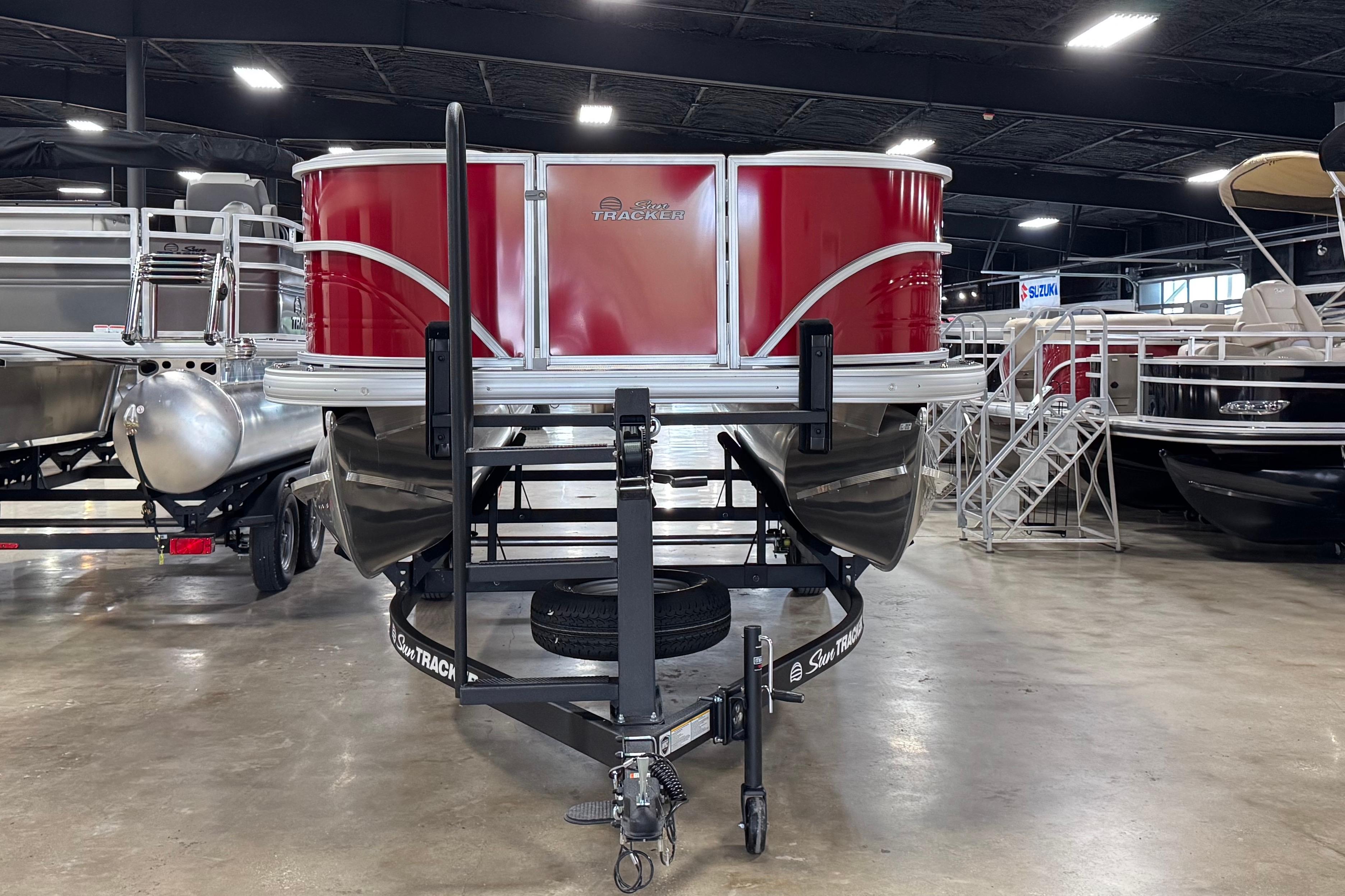 2026 Sun Tracker Party Barge 18 DLX pontoon boat on display in showroom.