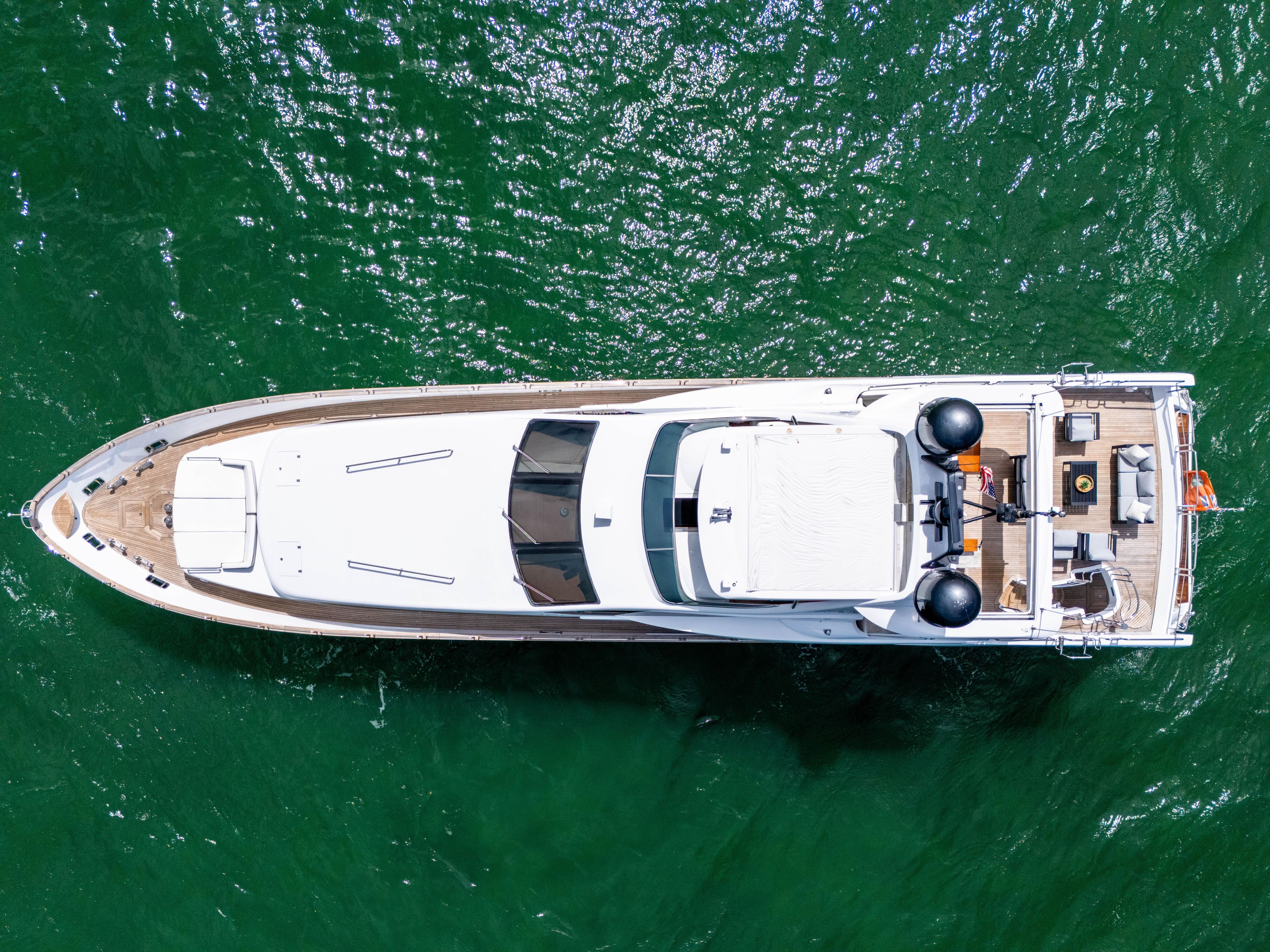 Aerial view of 2012 Azimut Grande 105 yacht on green water.