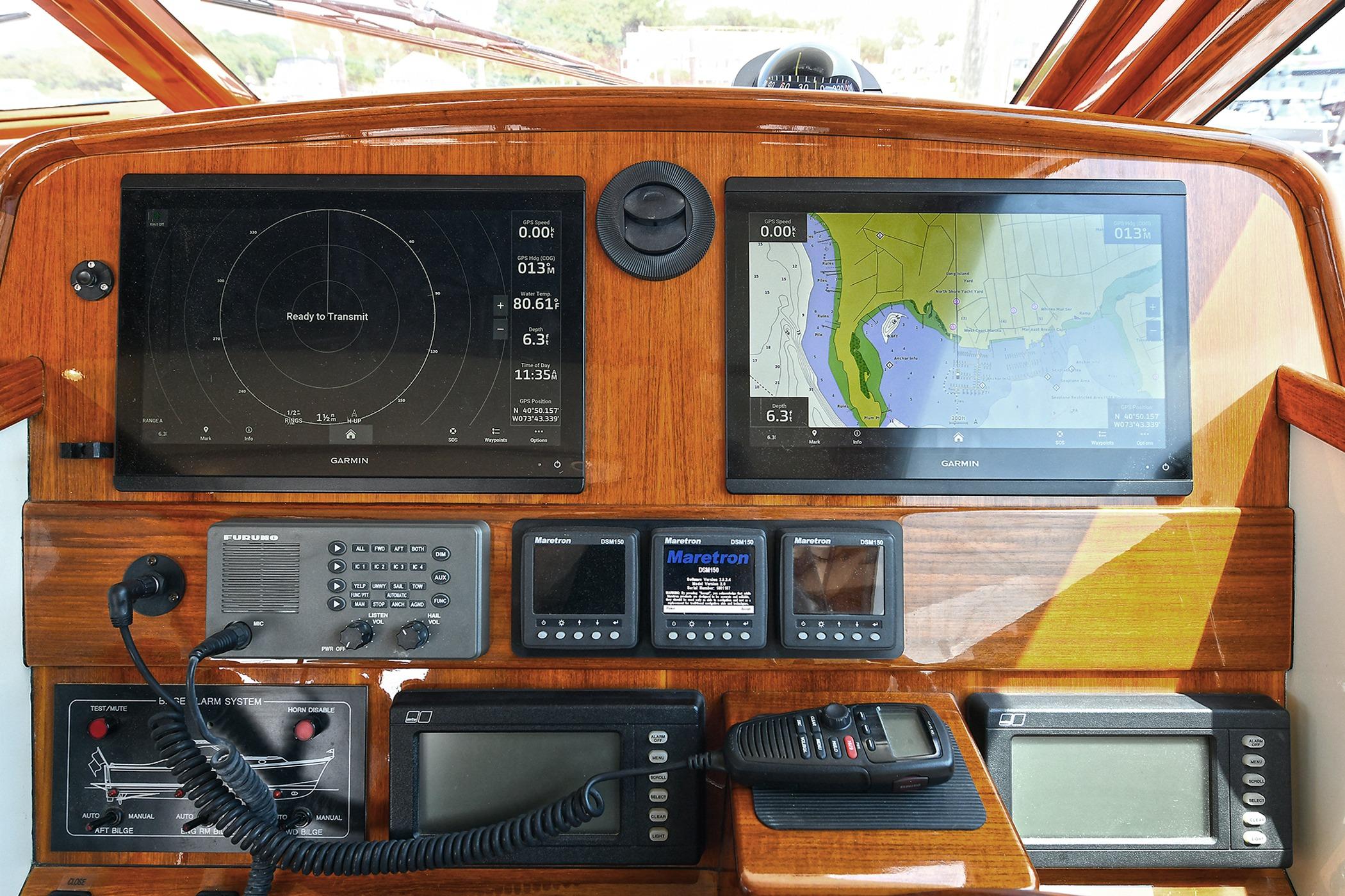 2005 San Juan Downeast Express helm with navigation screens and communication equipment.