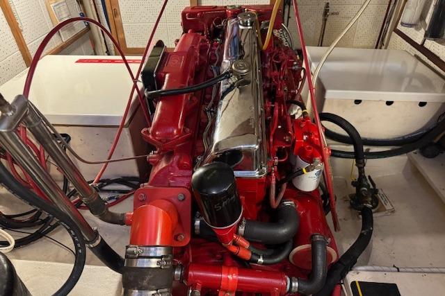 Engine room of a 1986 Krogen 42 Classic, featuring a red marine engine.
