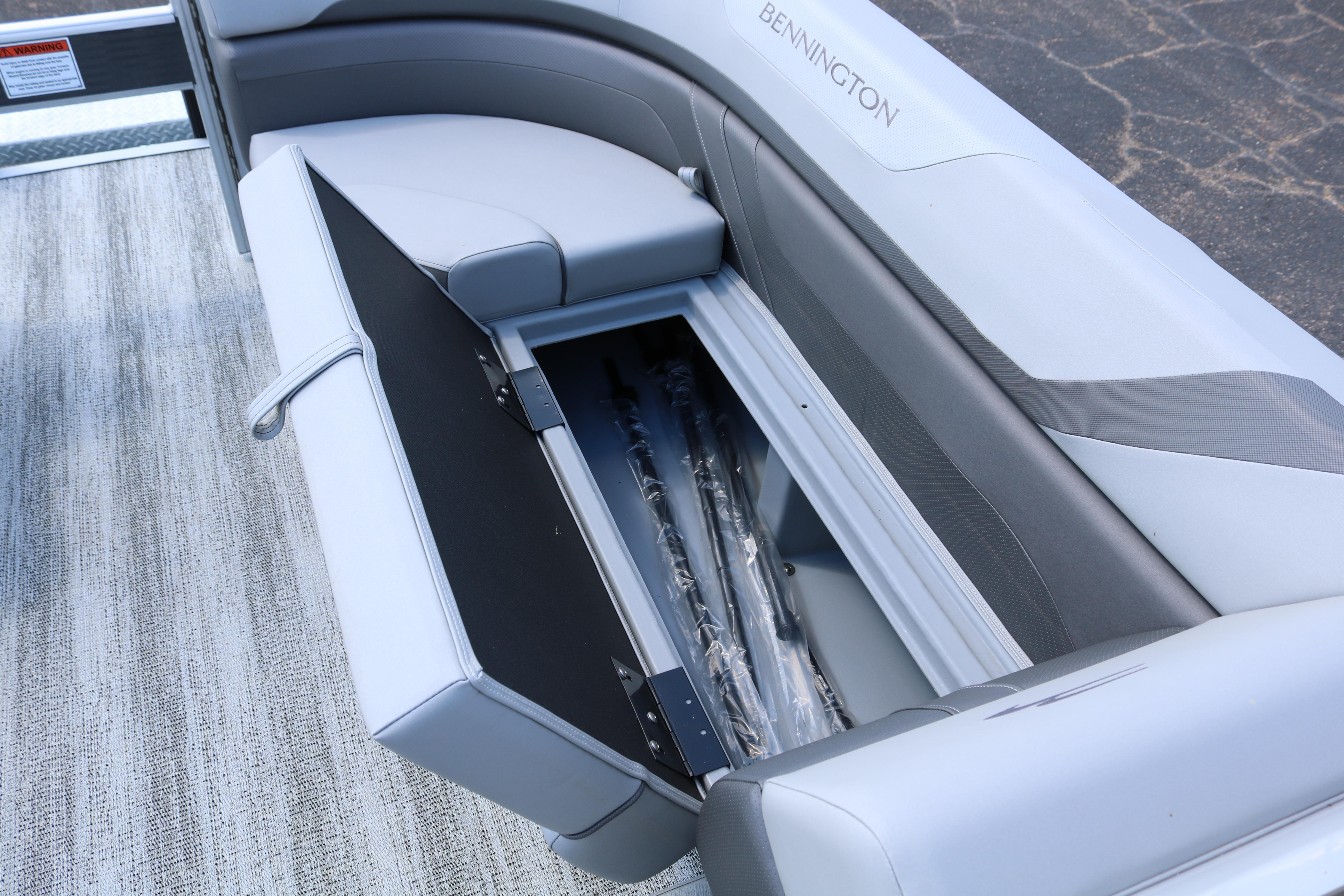 2026 Bennington 20SXSNP REAR FISH boat with open storage compartment.