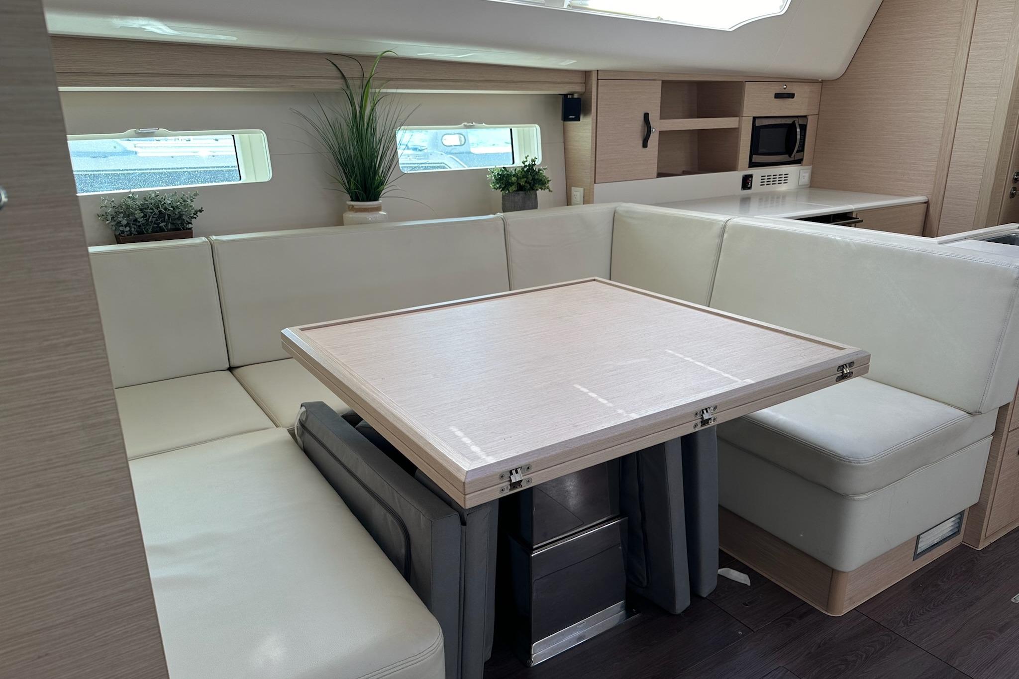 Luxurious interior of a 2018 Jeanneau 51 yacht with elegant seating and modern decor.