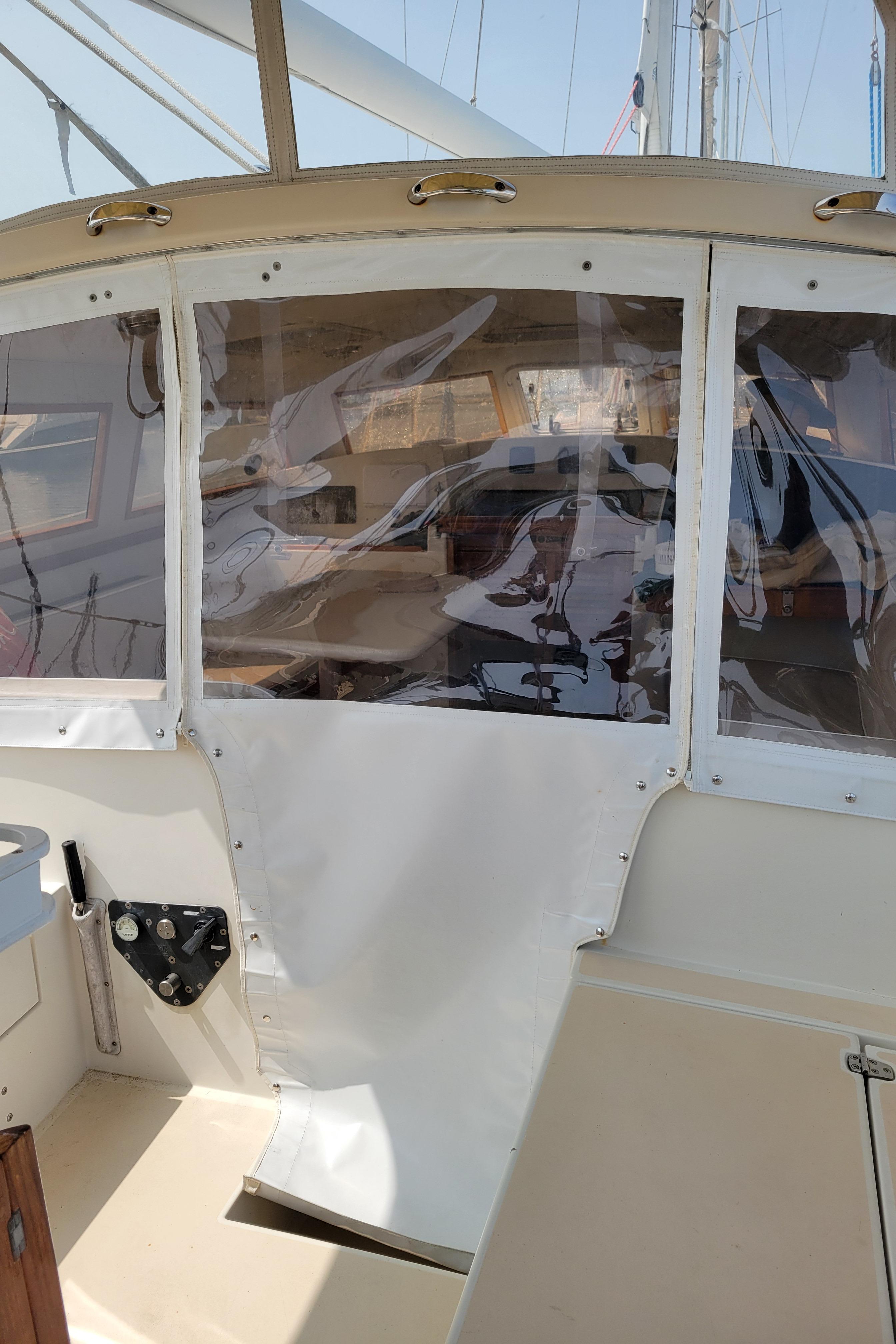 1996 Little Harbor 51 Pilothouse interior with clear panels and beige seating.