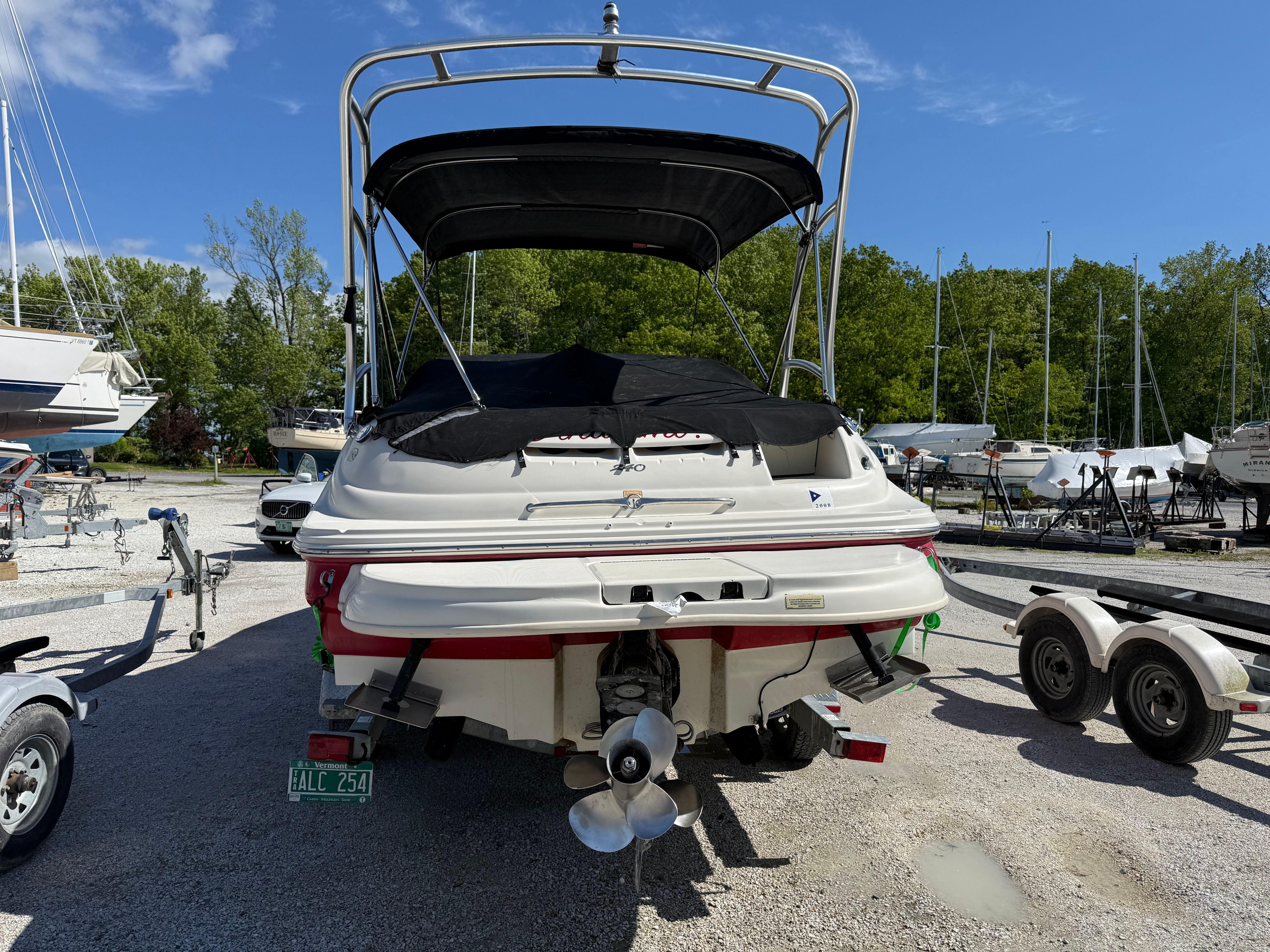 Rear view of a 2005 Sea Ray 240 Sundeck on a trailer.