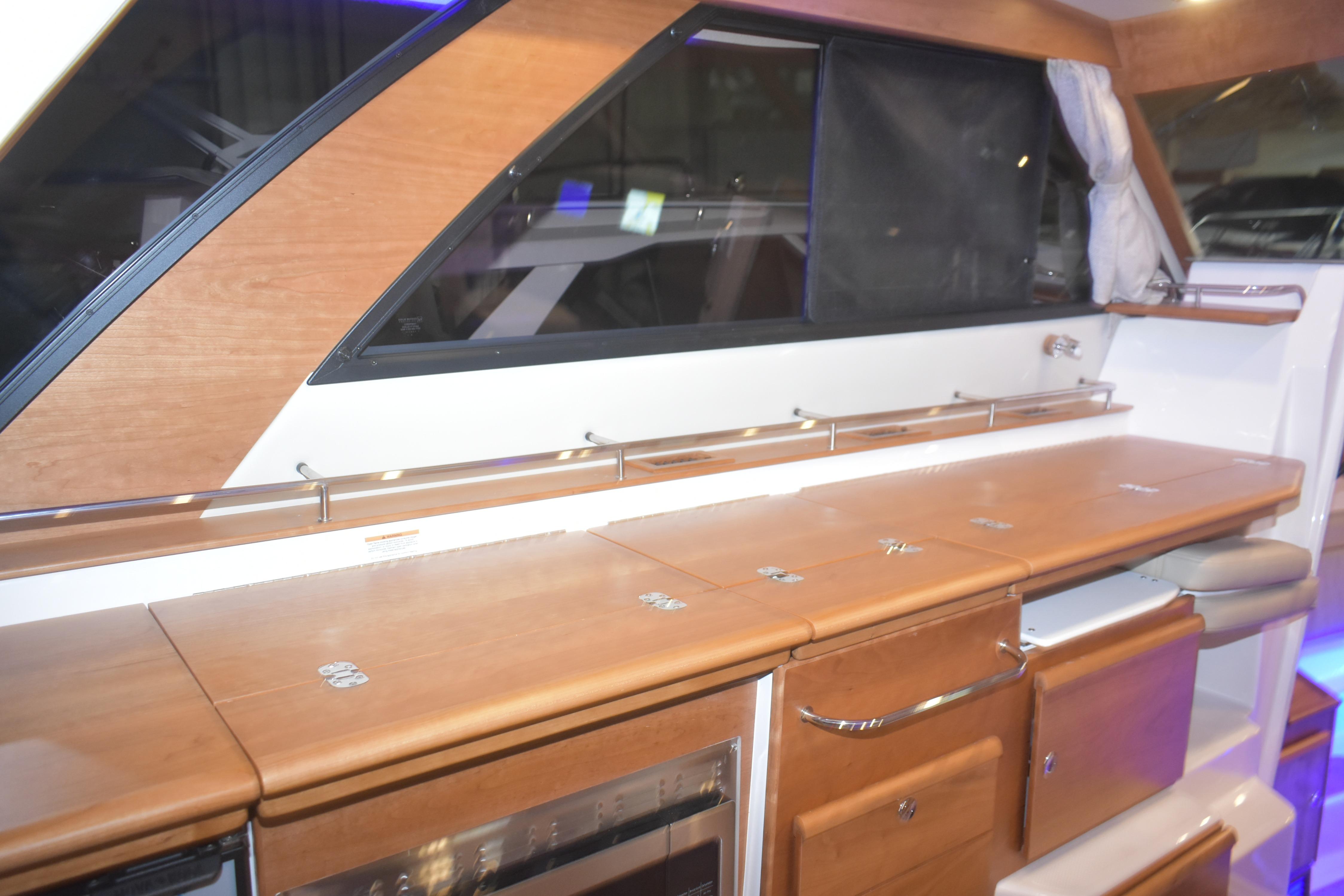 Interior of 2026 Cutwater C-32 CB yacht with sleek wooden cabinetry and modern design.