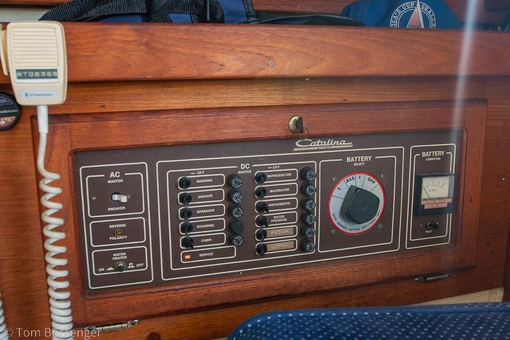 Electrical control panel of a 1987 Catalina 36 yacht, featuring AC/DC switches and battery selector.