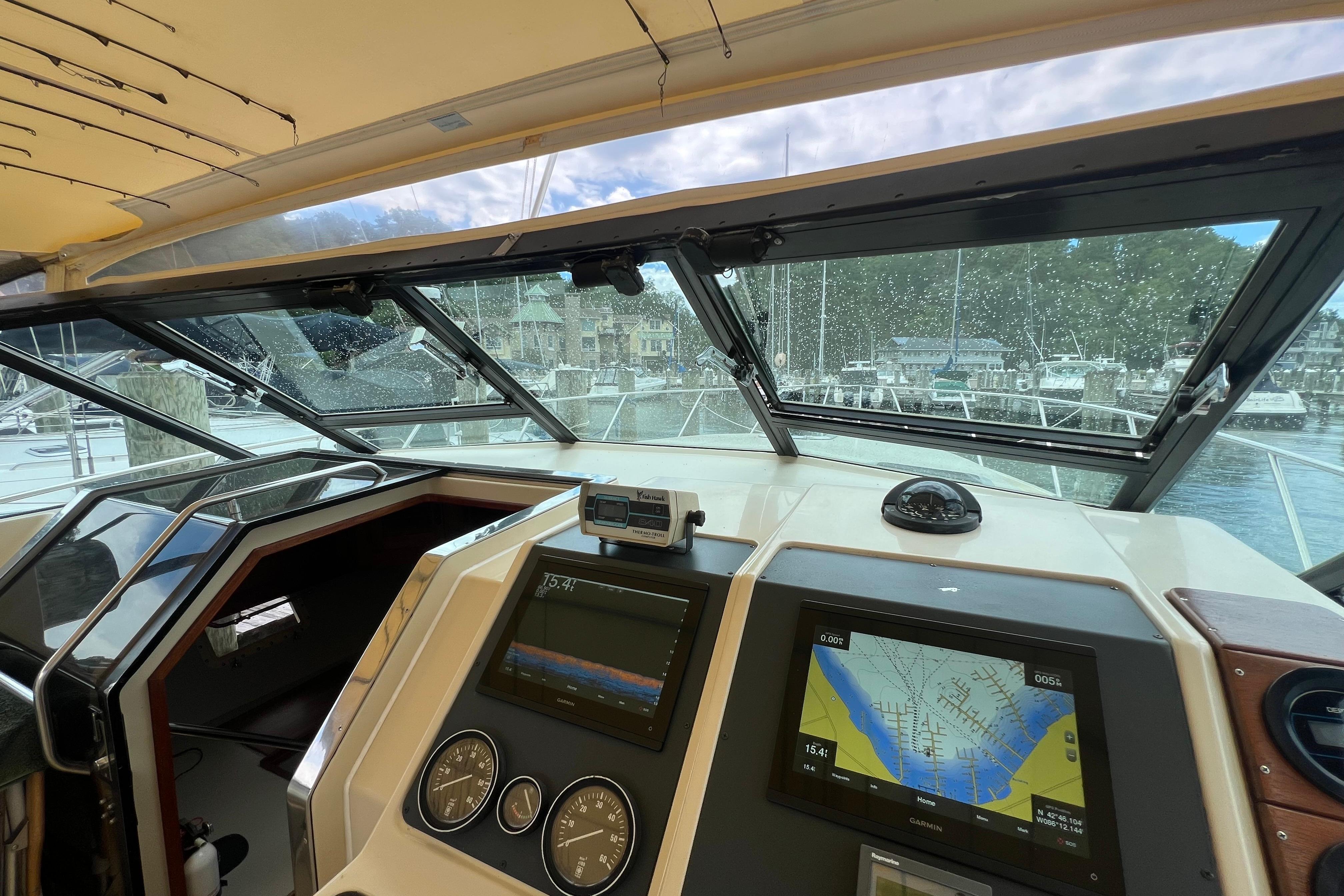 Interior view of 1985 Tiara 36 OPEN yacht cockpit with navigation equipment.