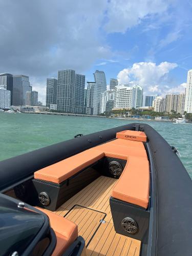 2024 Onda Magna boat cruising near city skyline on a sunny day.