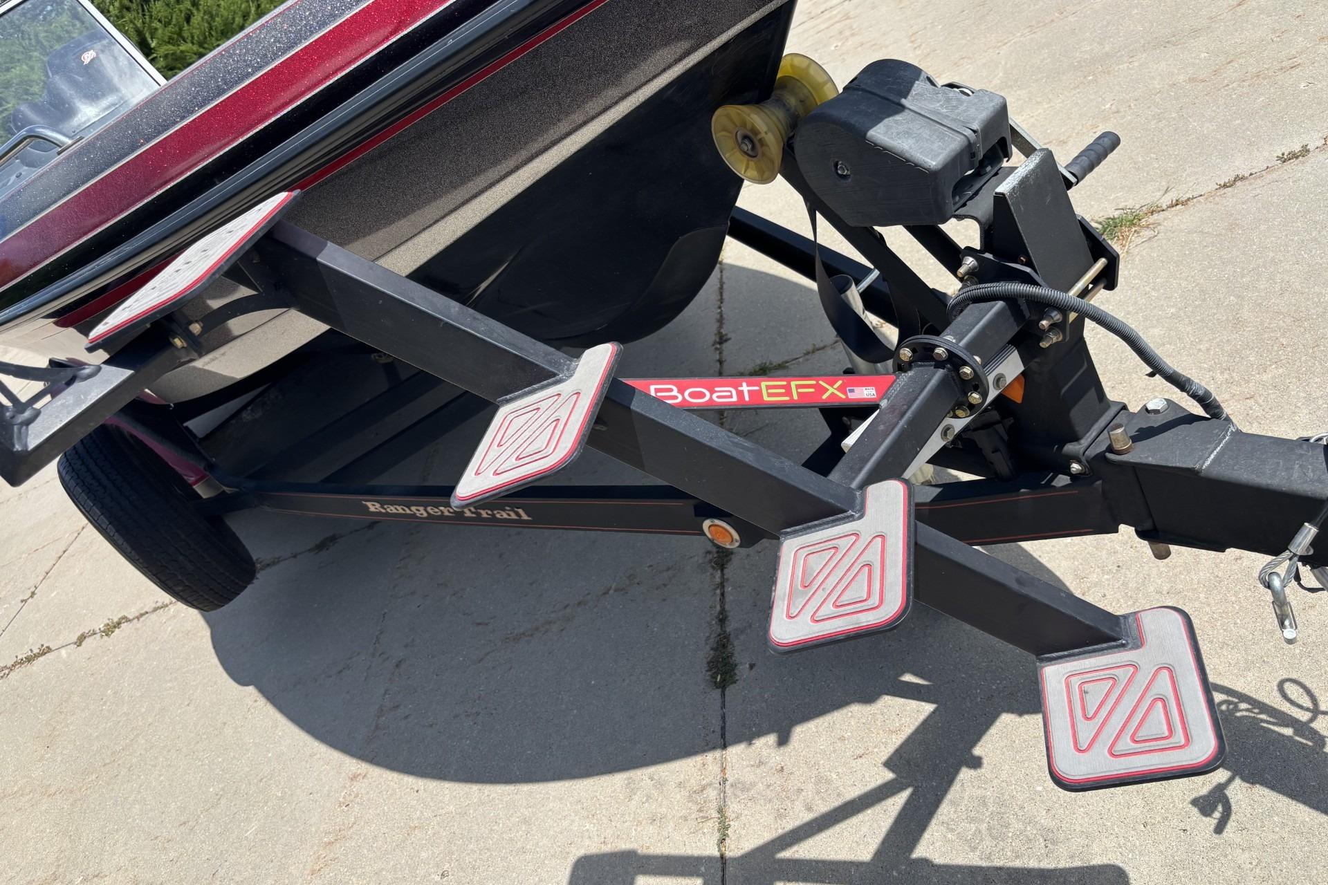 2011 Ranger 620 VS boat trailer with BoatEFX steps on concrete driveway.
