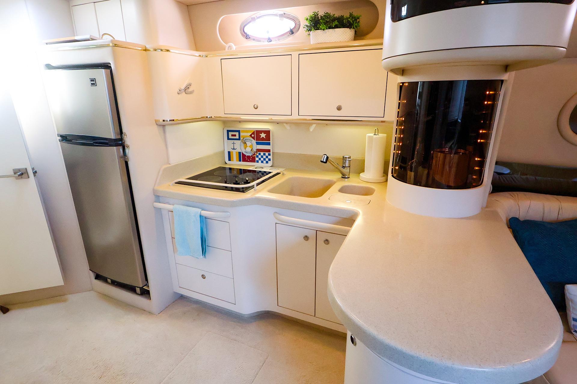 Luxurious 1998 Sea Ray 500 Sundancer yacht kitchen with modern appliances and sleek design.